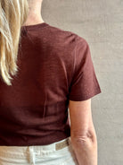 Image of woman wearing premium polished layer SPRWMN classic brown wool tee shirt with crew neck and short sleeve
