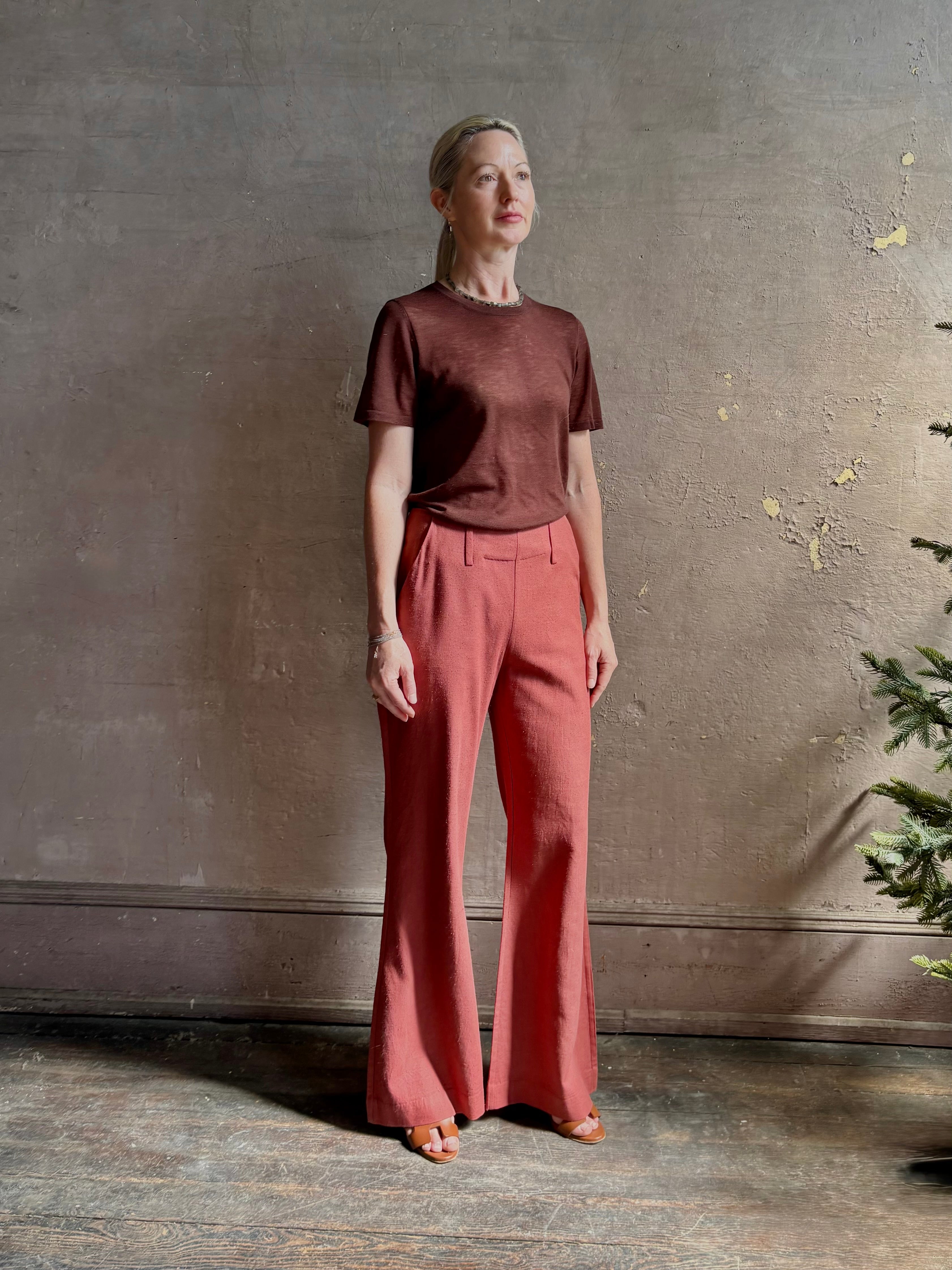 Mature woman wearing premium polished layer SPRWMN classic brown wool tee shirt with crew neck and short sleeves and very light weight for a summer elevated basic or cool weather layering