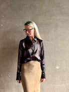 woman wearing luxury brand SPRWMN Fonda silk button up shirt in a black and brown stripe modern classic