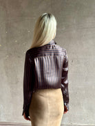 woman wearing luxury brand SPRWMN Fonda silk button up shirt in a black and brown stripe modern classic