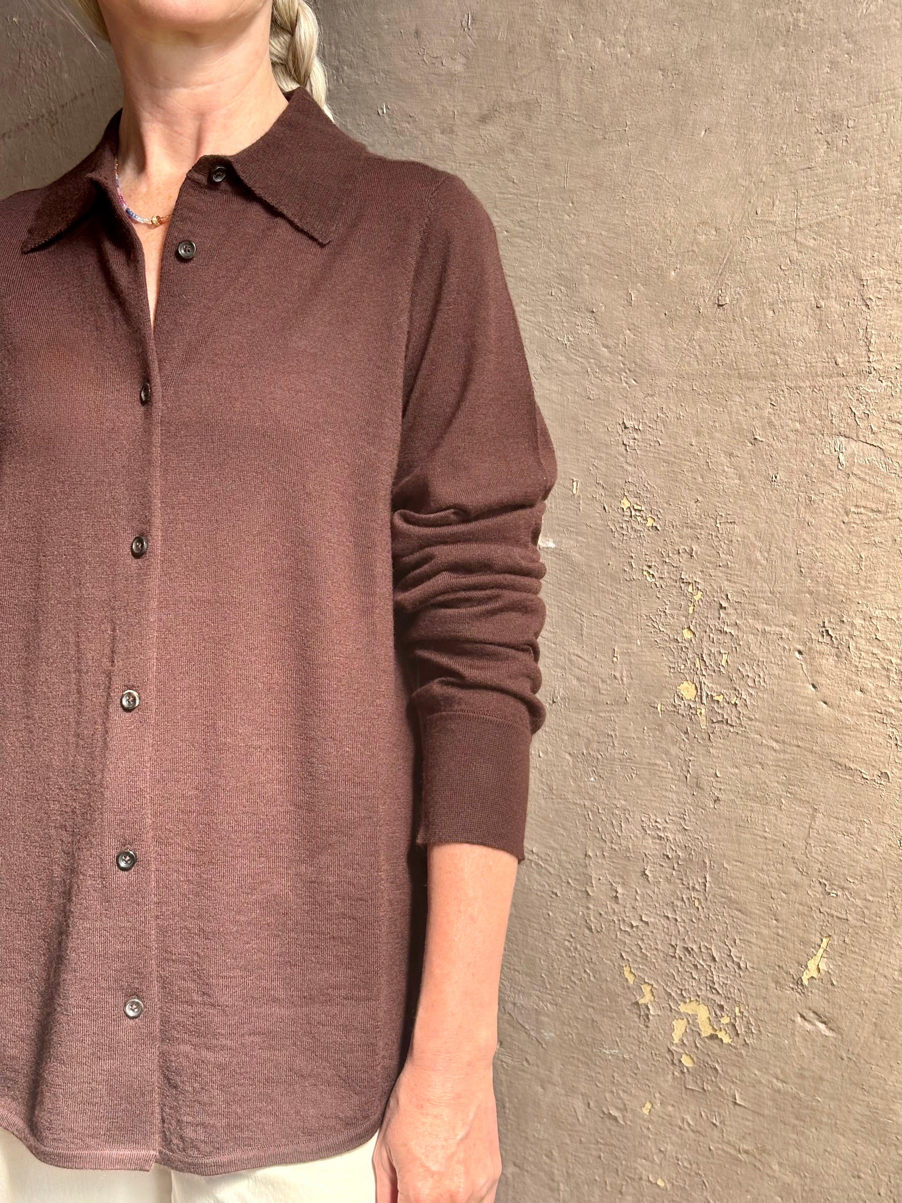 Mature woman wearing elevated casual wear button front Fonda top by SPRWMN in chocolate brown cashmere with long sleeves and a collar