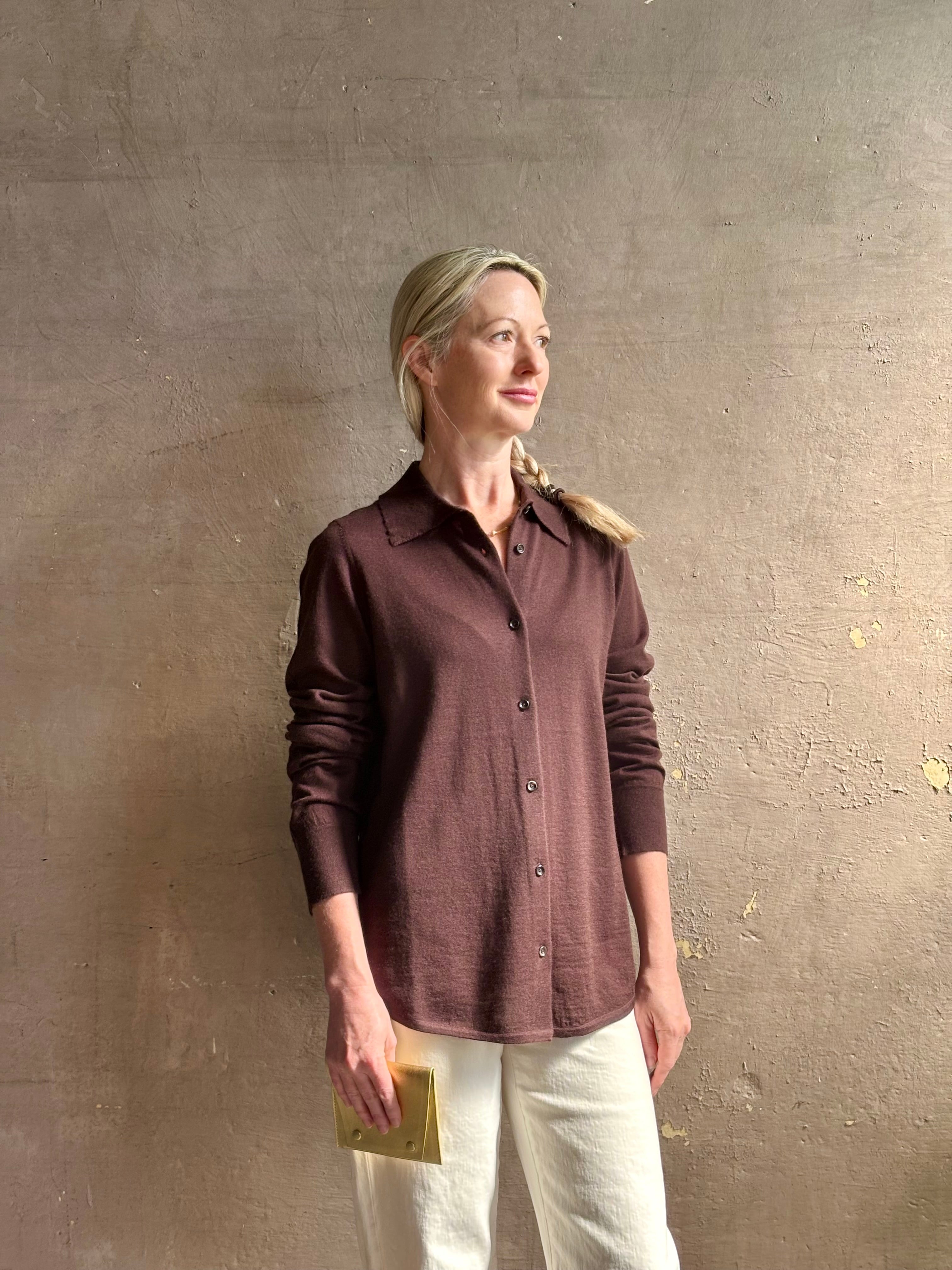Mature woman wearing elevated casual wear button front Fonda top by SPRWMN in chocolate brown cashmere with long sleeves and a collar