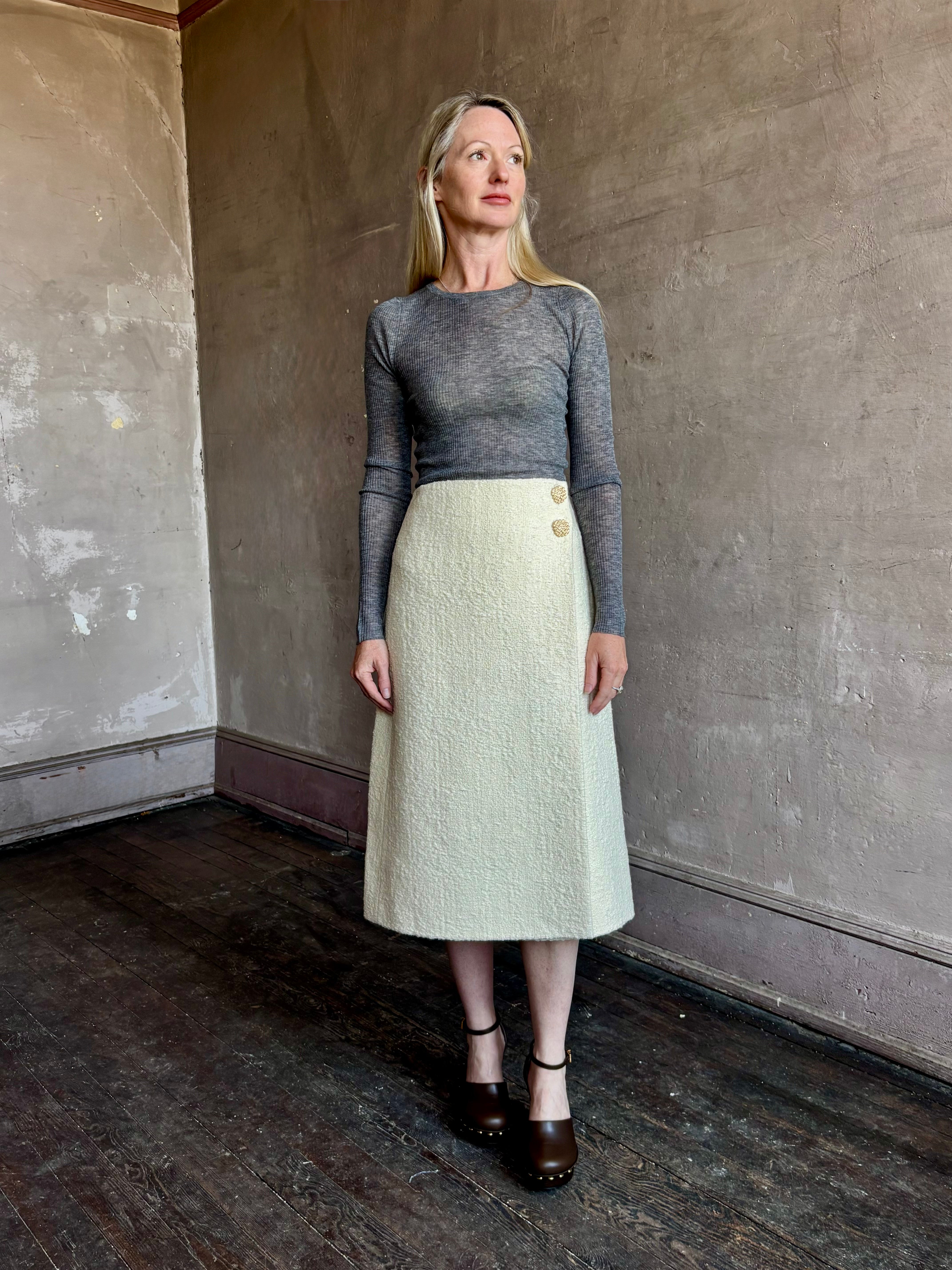 Image of mature woman wearing luxury women's clothing SPRWMN long sleeve baby tee with subtle transparency and lightweight knit