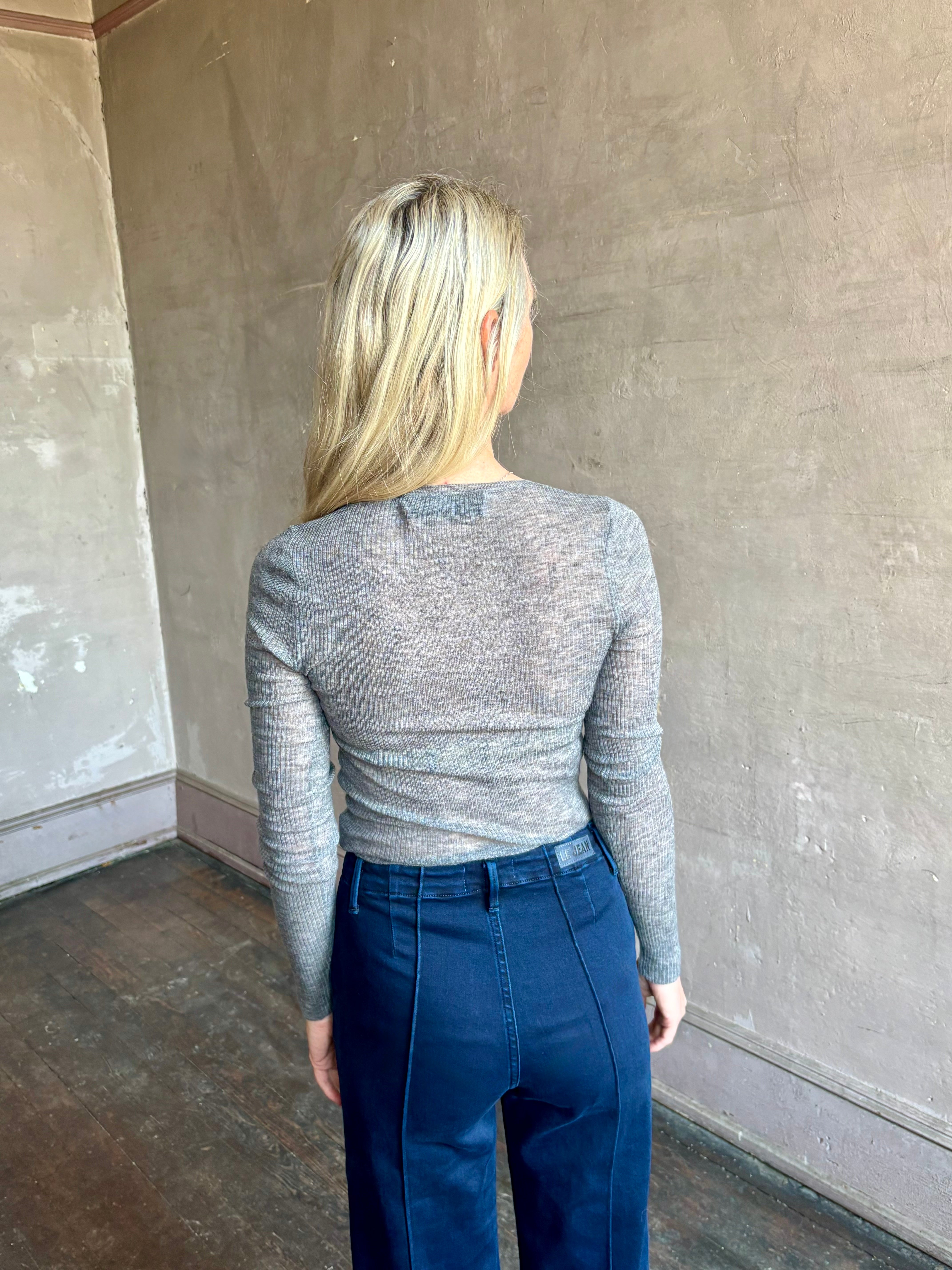 Image of mature woman wearing luxury women's clothing SPRWMN long sleeve baby tee with subtle transparency and lightweight knit