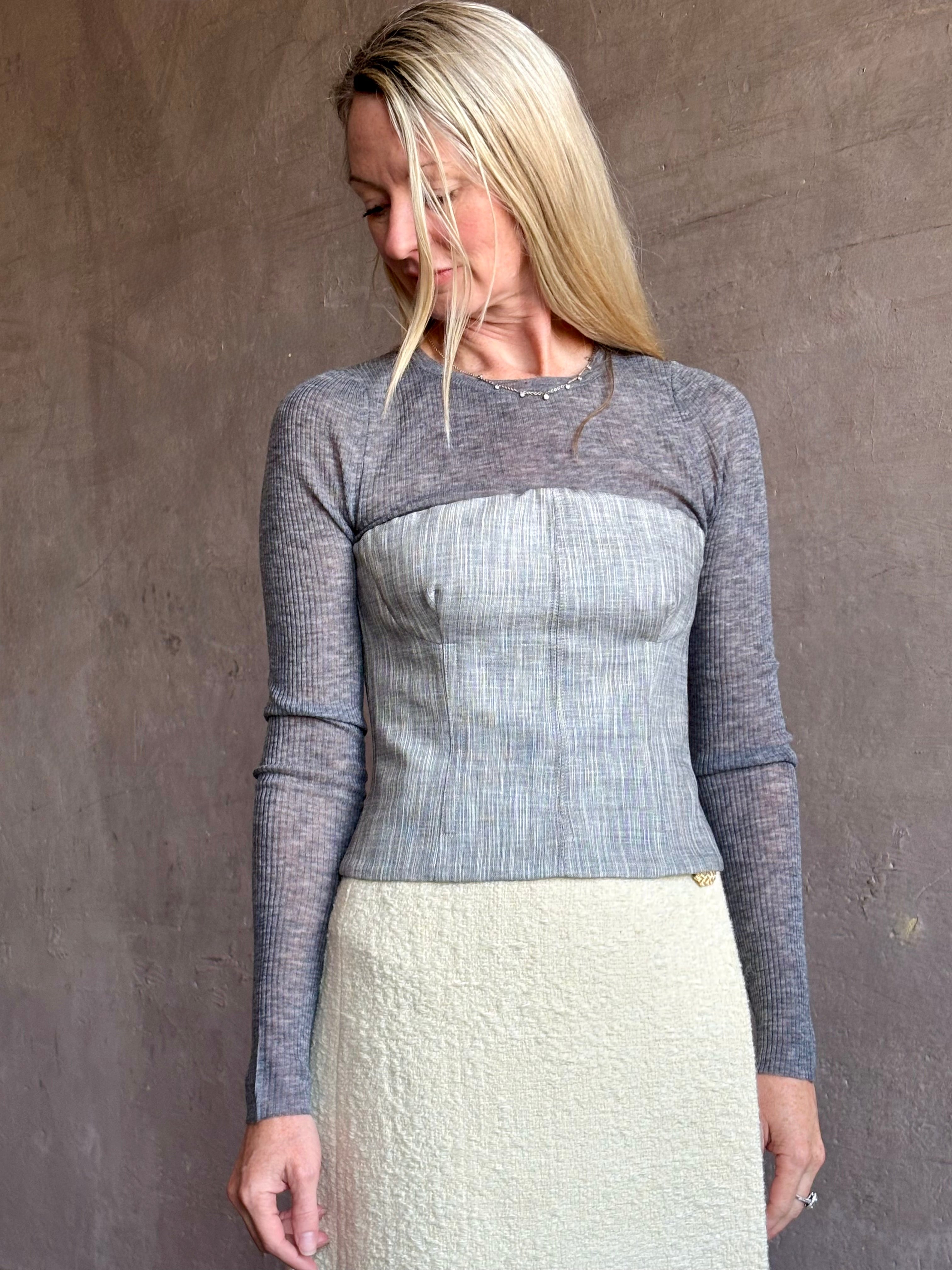 Image of mature woman wearing luxurious SPRWMN long sleeve baby tee with subtle transparency and lightweight knit perfect for layering