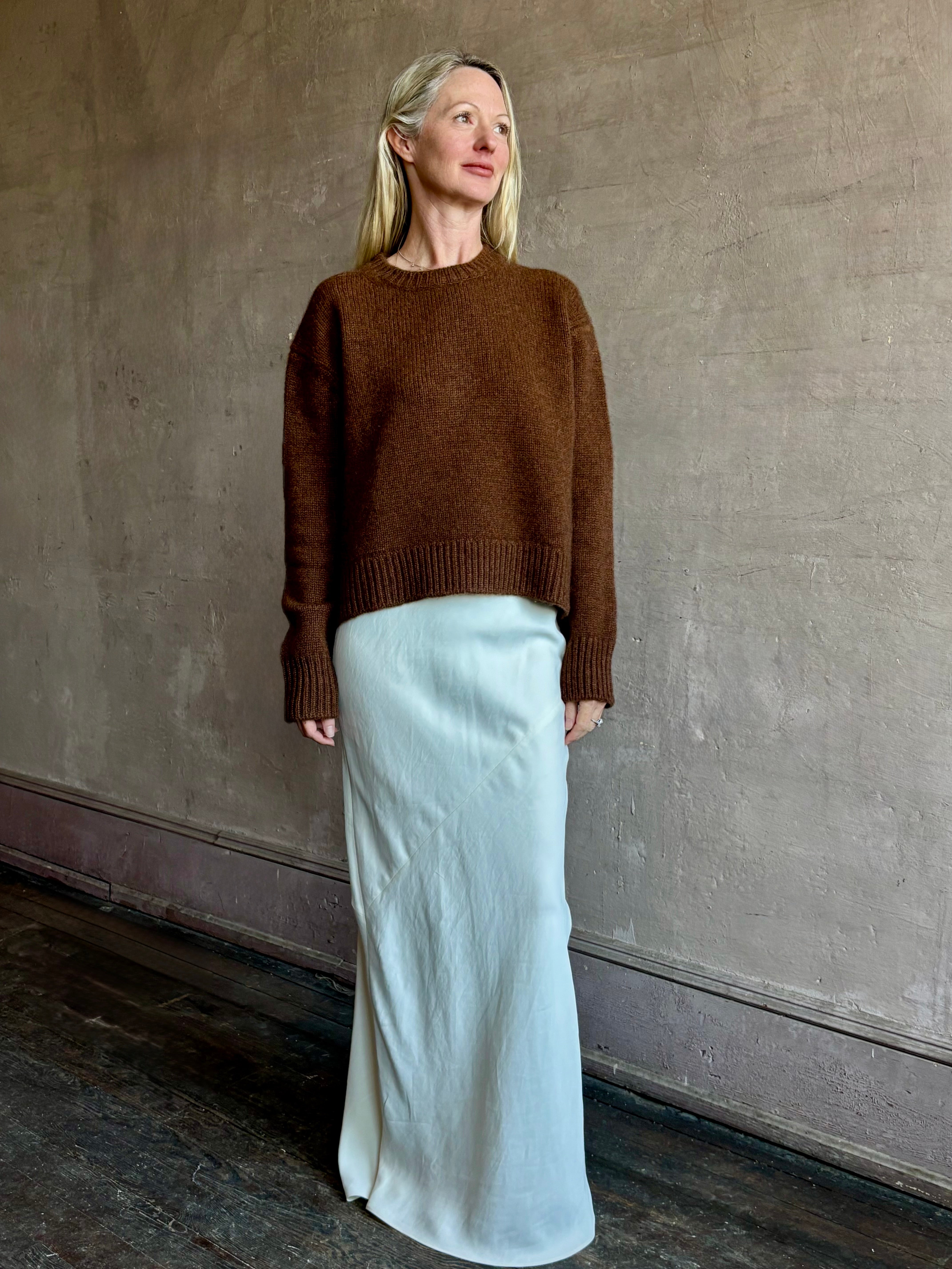 Image of mature woman wearing women's luxury brand SPRWNM oversized long sleeve brown sweater with crewneck