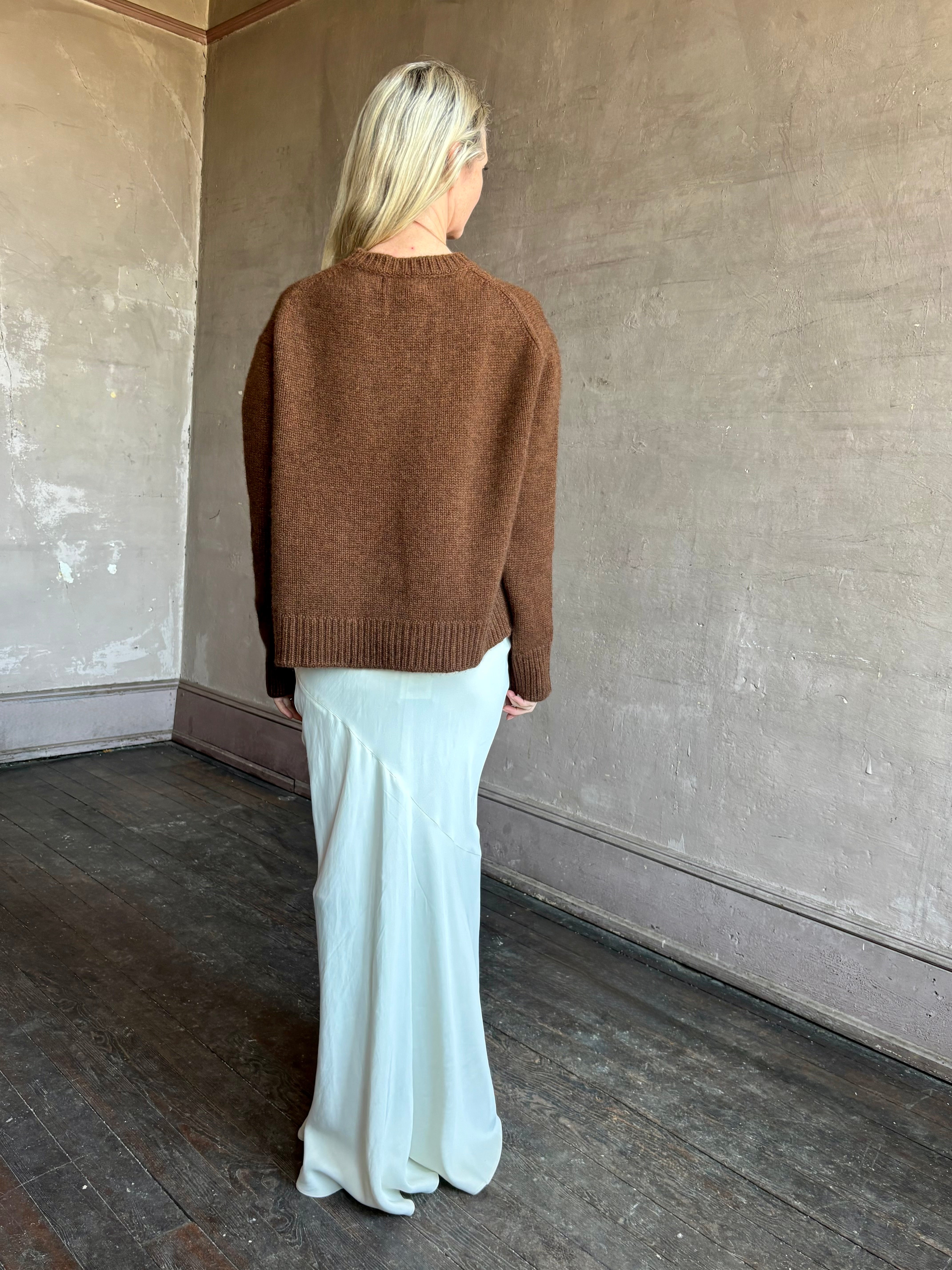 Image of mature woman wearing women's luxury brand SPRWNM oversized long sleeve brown sweater with crewneck