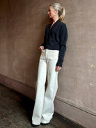 Woman wearing SPRWMN Mia luxury knitwear Cardigan that can transition from professional layering to casual comfort