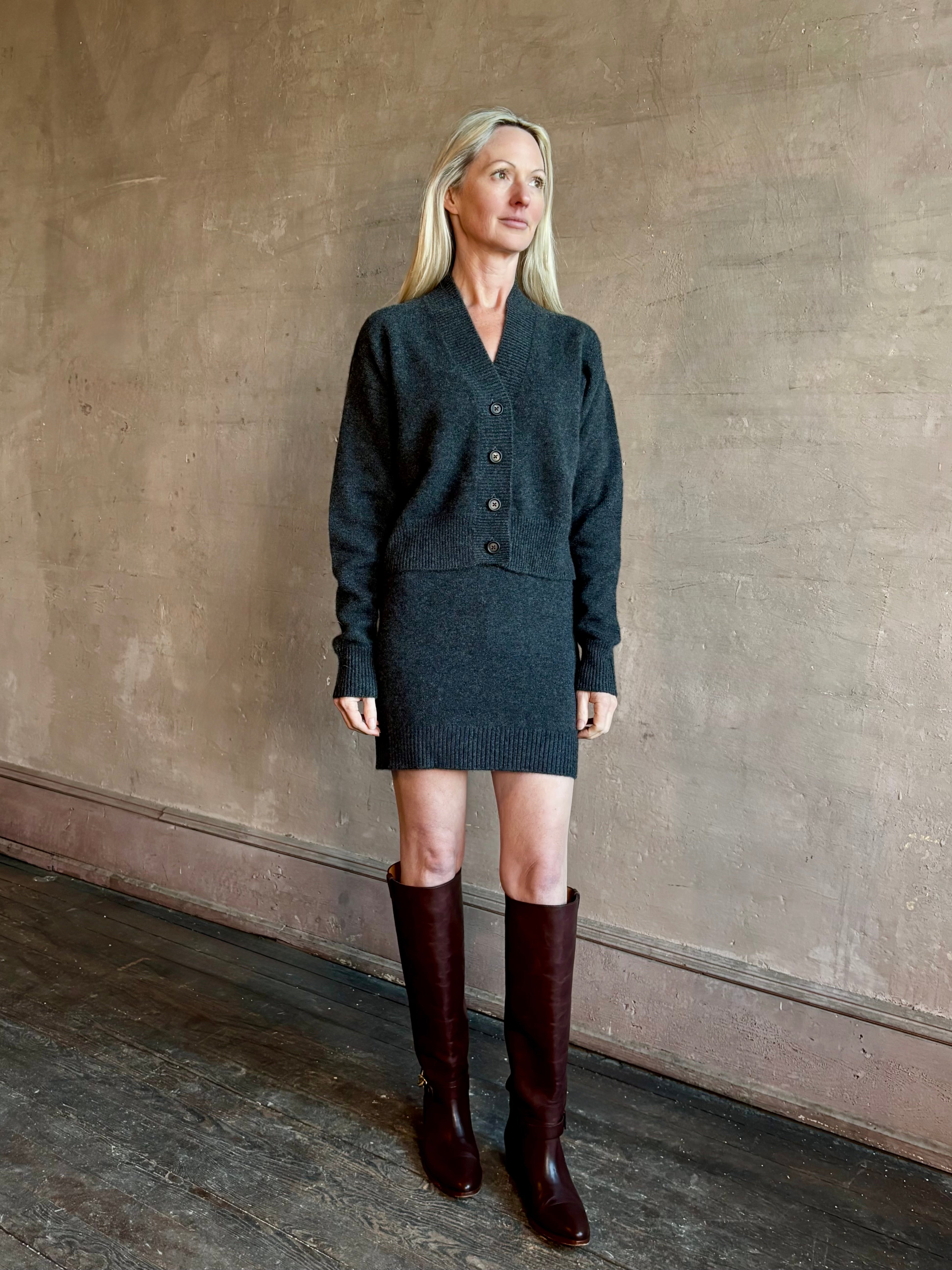 Image of mature woman wearing  SPRWMN Mia Skirt in charcoal grey luxury cashmere knitwear 