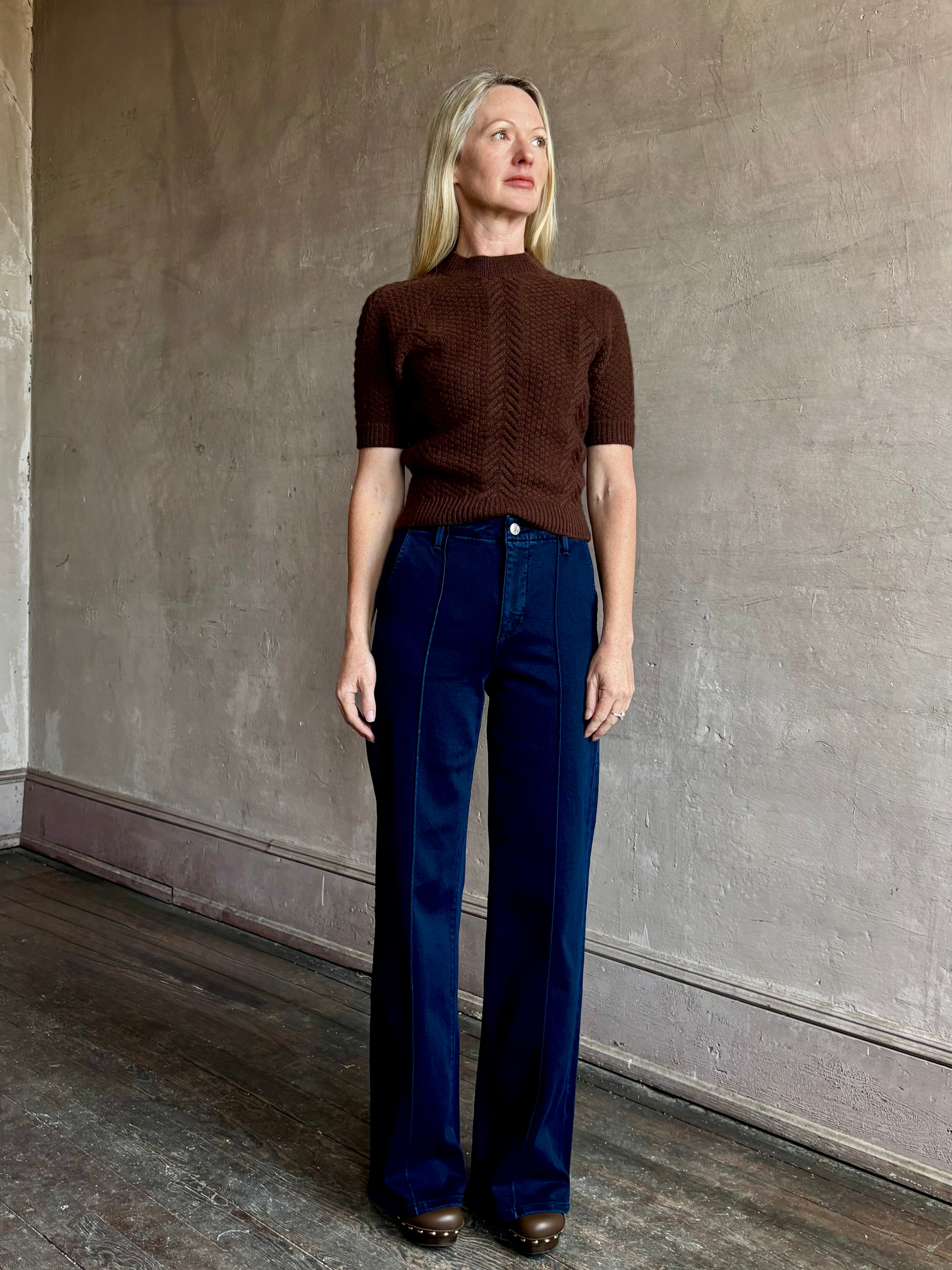 Image of mature woman wearing high end luxury designer SPRWMN short sleeve brown cashmere sweater with beautiful cable texture pattern