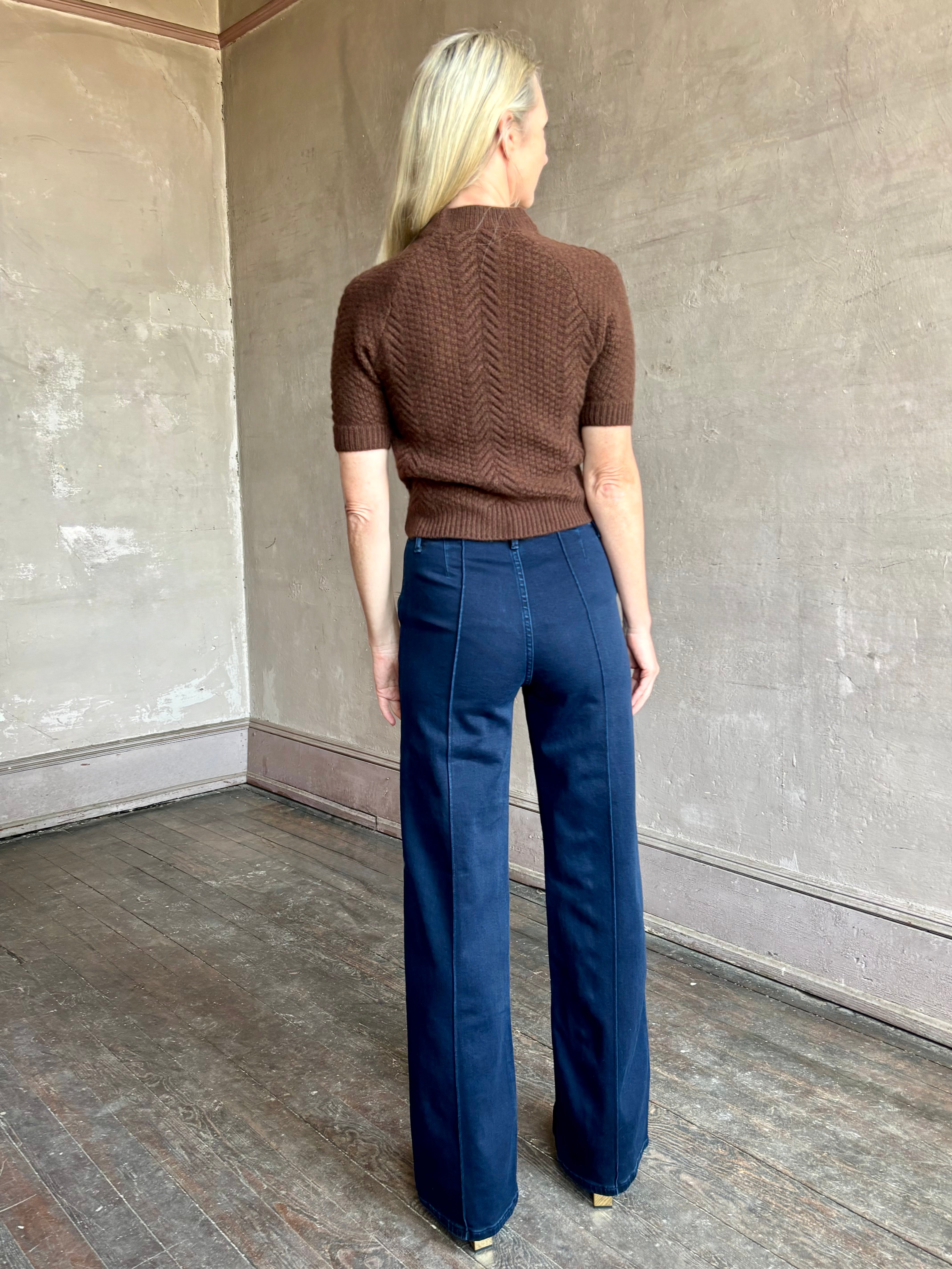 Image of mature woman wearing high end luxury designer SPRWMN short sleeve brown cashmere sweater with beautiful cable texture pattern