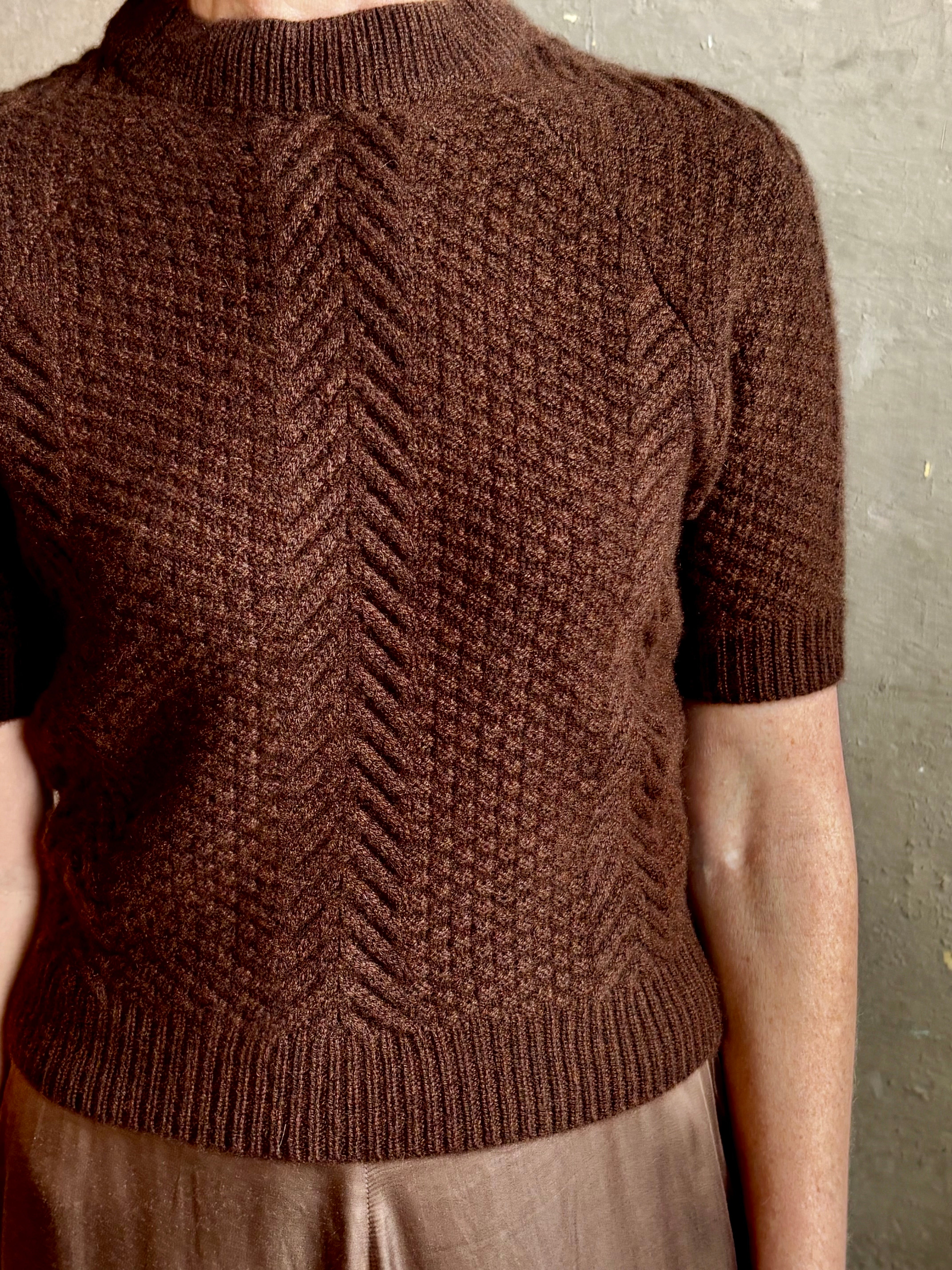 mature woman wearing luxury designer SPRWMN short sleeve brown cashmere sweater with cable texture crew neck