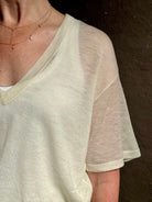 woman wearing SPRWMN lightweight ivory wool sweater short sleeve v-neck in relaxed fit t-shirt design