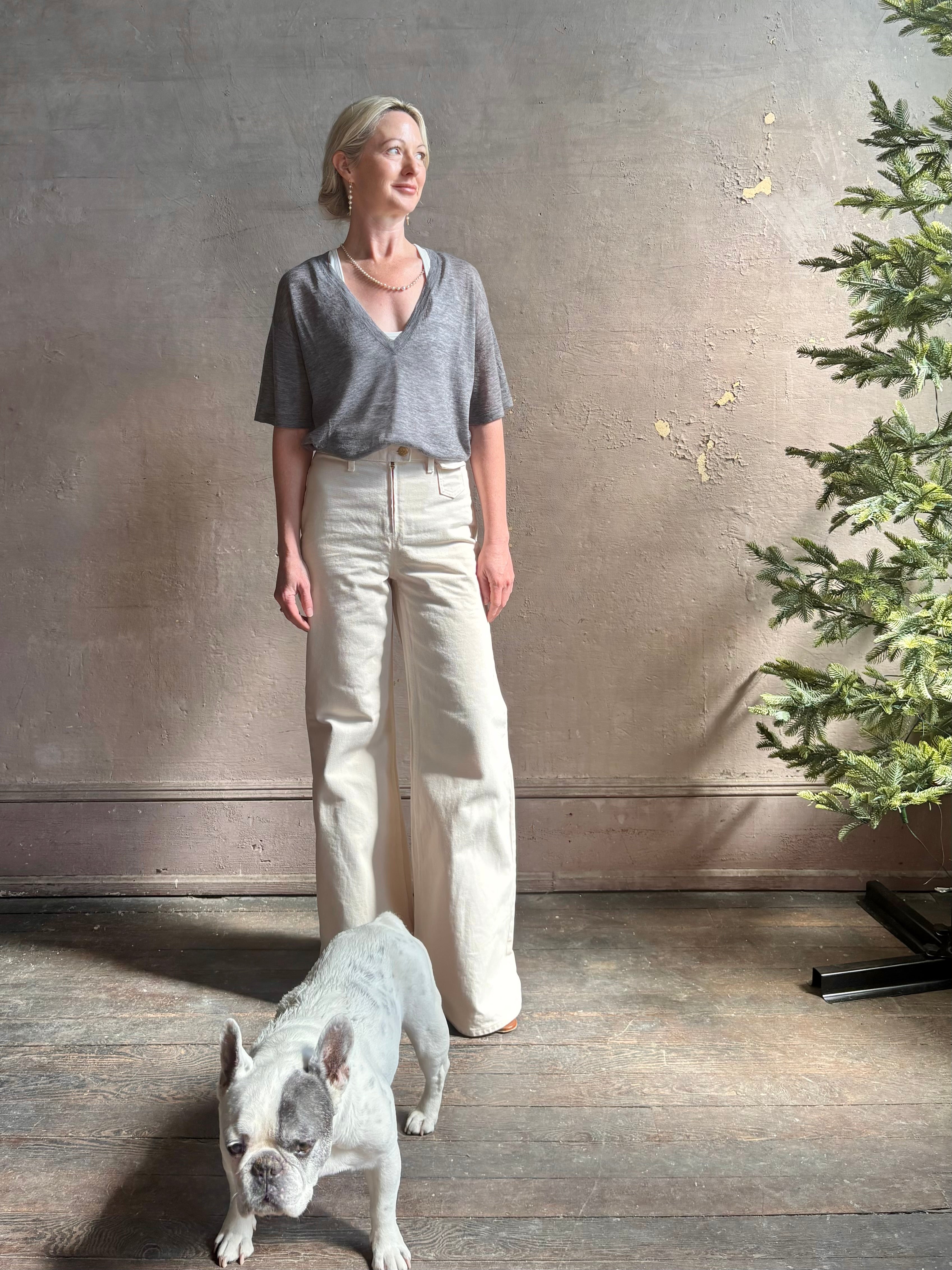 Mature woman wearing premium polished layer SPRWMN grey wool tee shirt with a v-neck and short sleeves