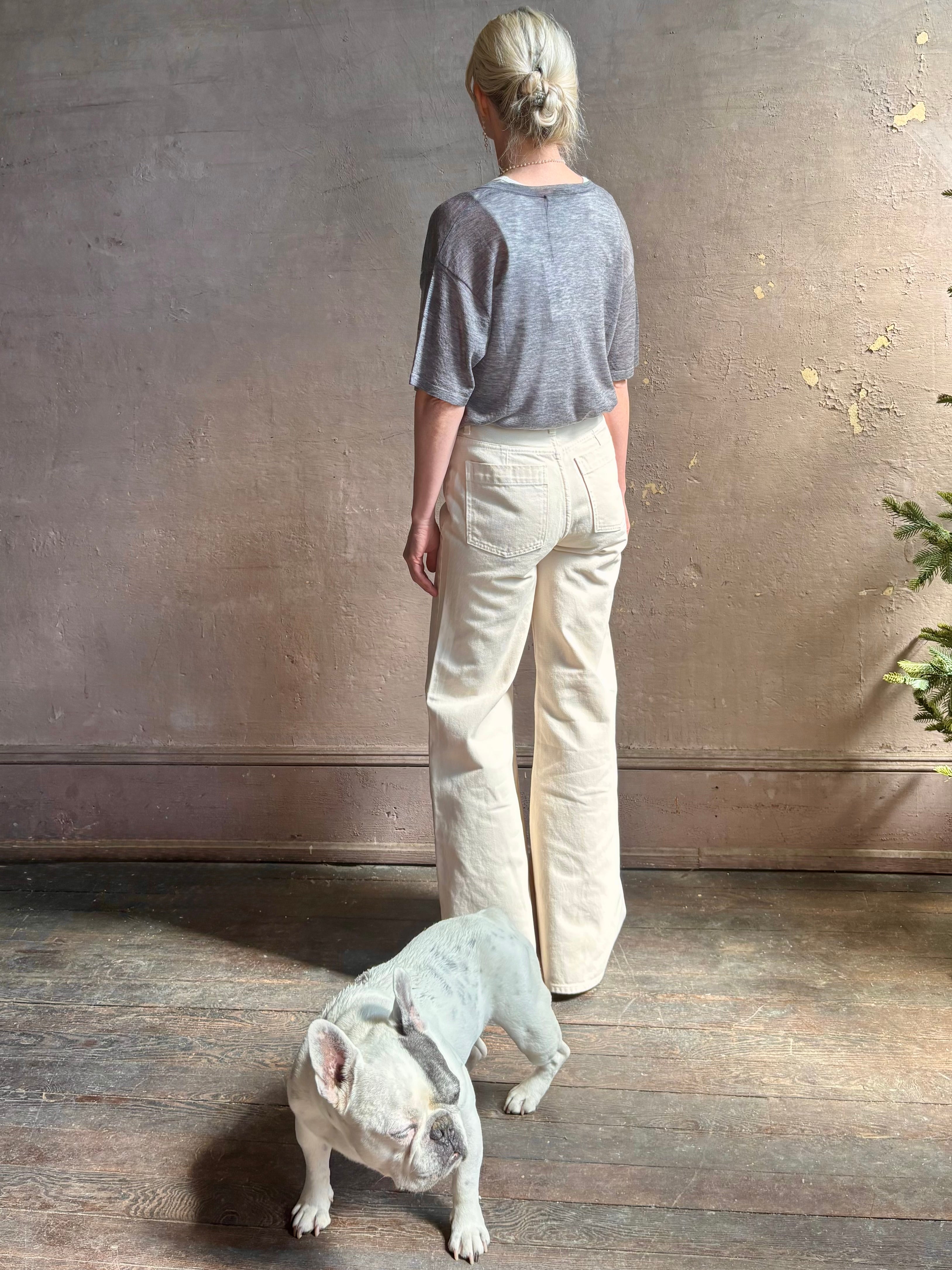 Mature woman wearing premium polished layer SPRWMN grey wool tee shirt with a v-neck and short sleeves