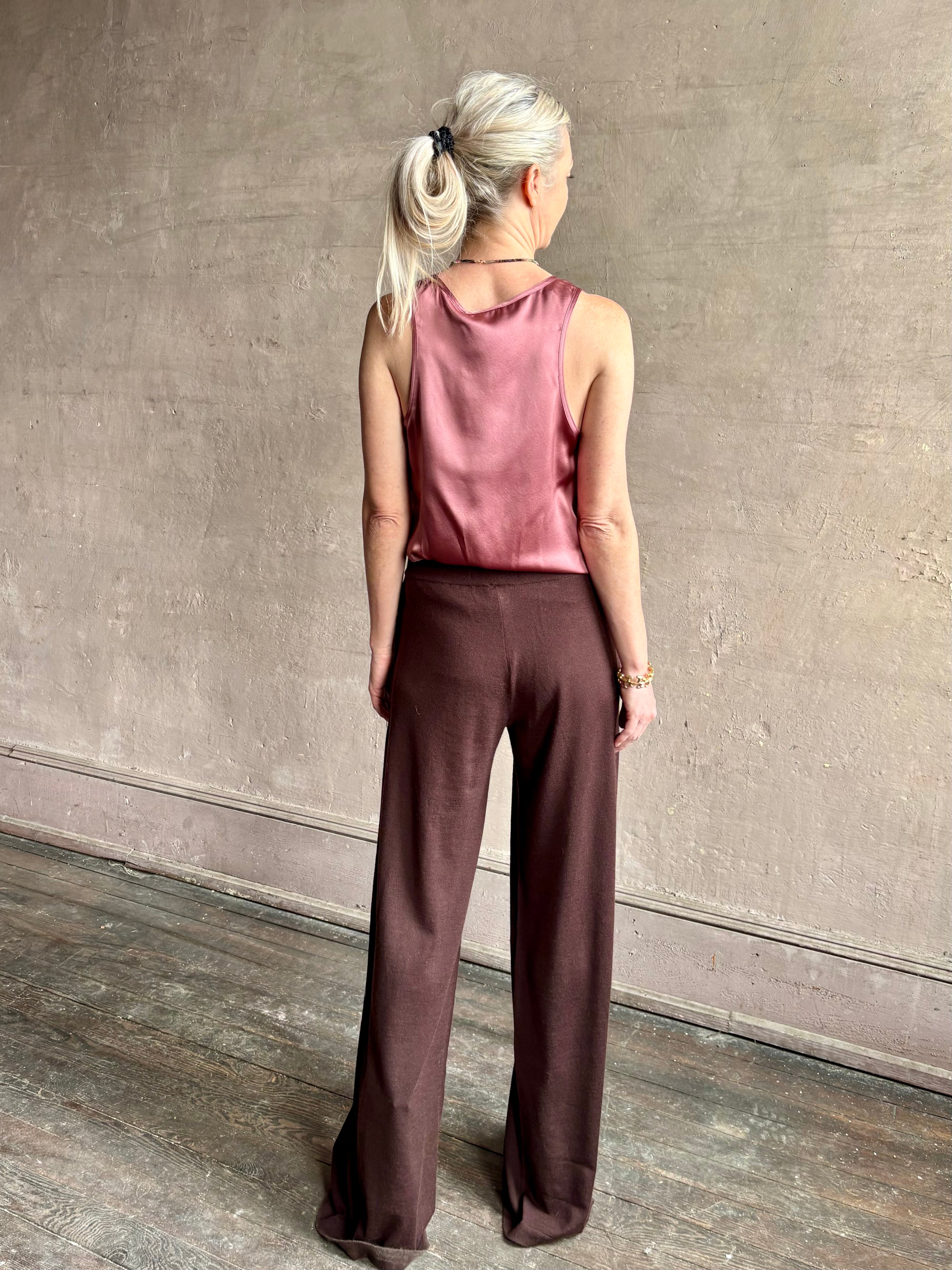 Image of woman wearing premium knit cashmere chocolate brown pant by SPRWMN with elastic waistband and mid-rise and flowy wide leg