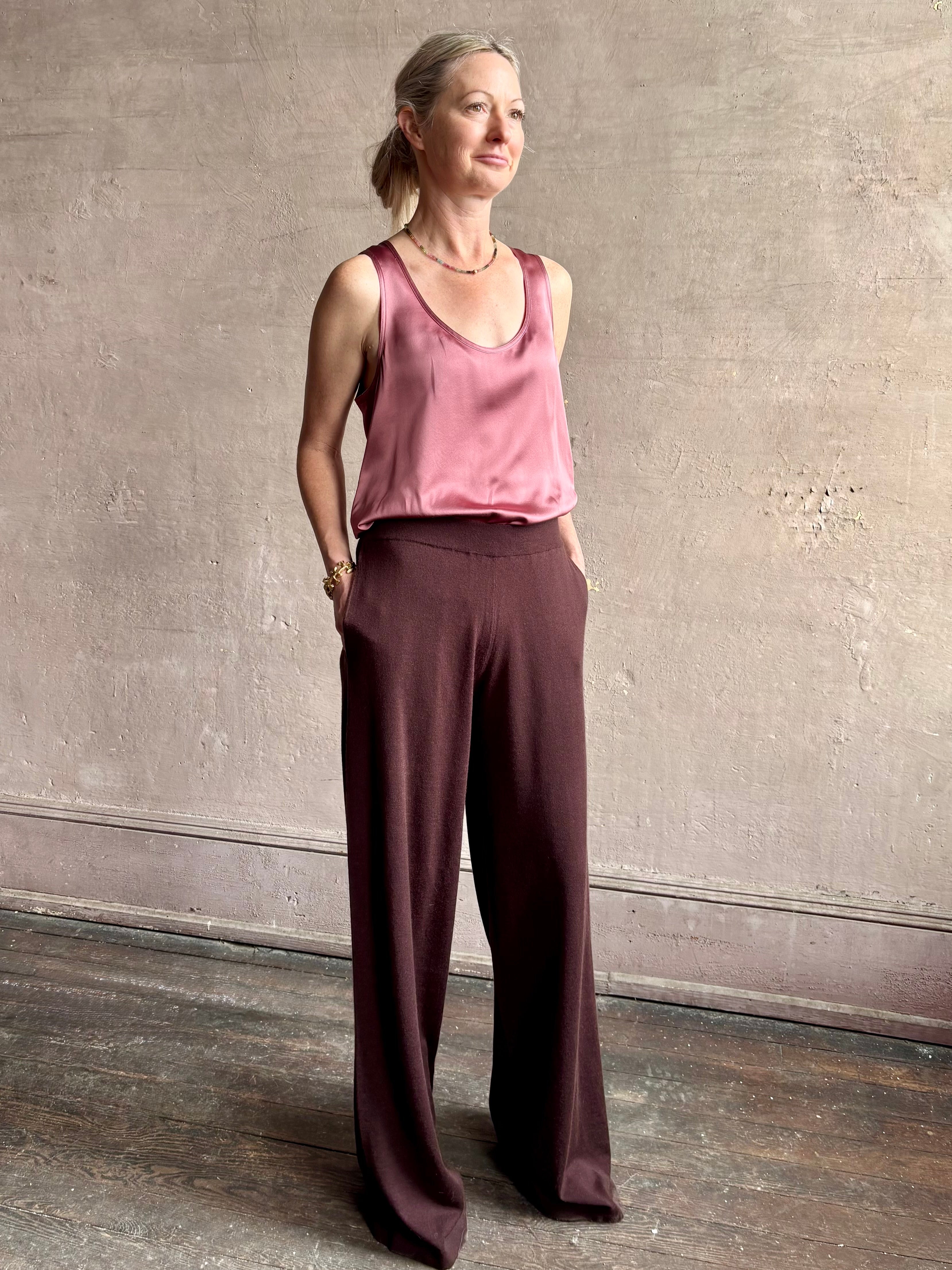 Image of woman wearing premium knit cashmere chocolate brown pant by SPRWMN with elastic waistband and mid-rise and flowy wide leg