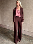 mature woman wearing SPRWMN premium knit cashmere brown pant elastic waistband  mid-rise wide leg