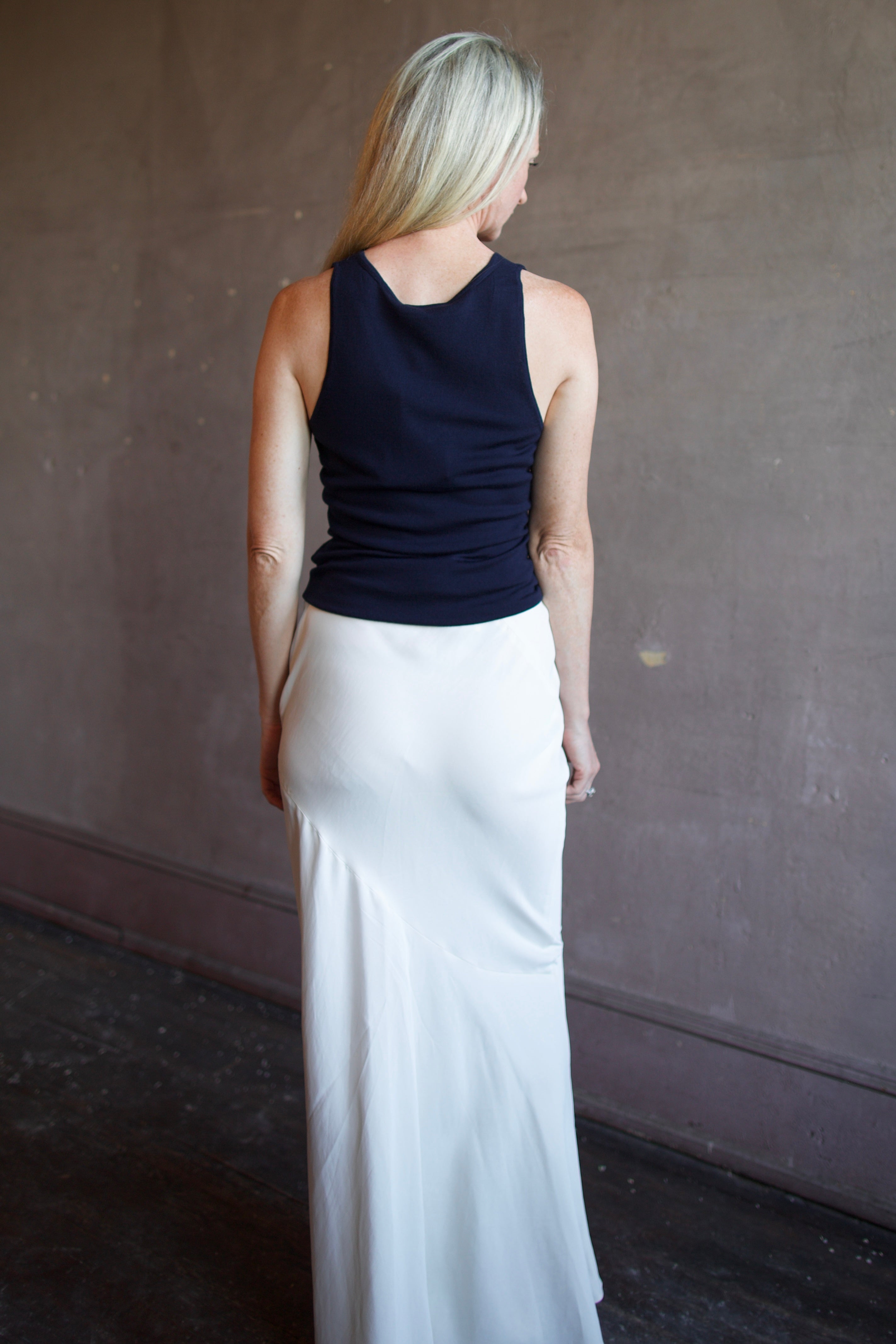 Model wearing luxury brand Sablyn Addyson v-neck layering tank in super fine merino wool for exceptional lightweight comfort