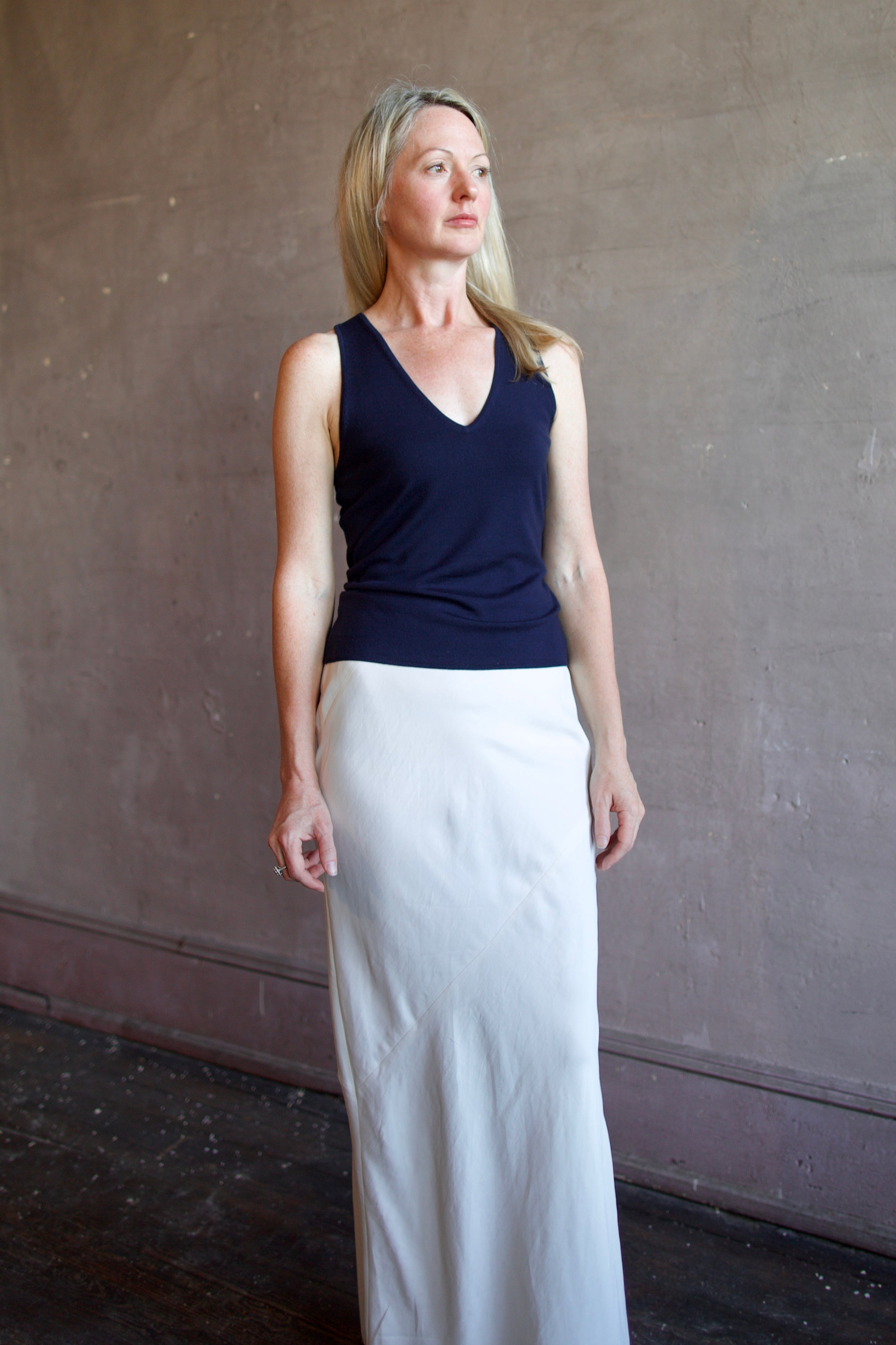 Model wearing luxury brand Sablyn Addyson v-neck layering tank in super fine merino wool for exceptional lightweight comfort