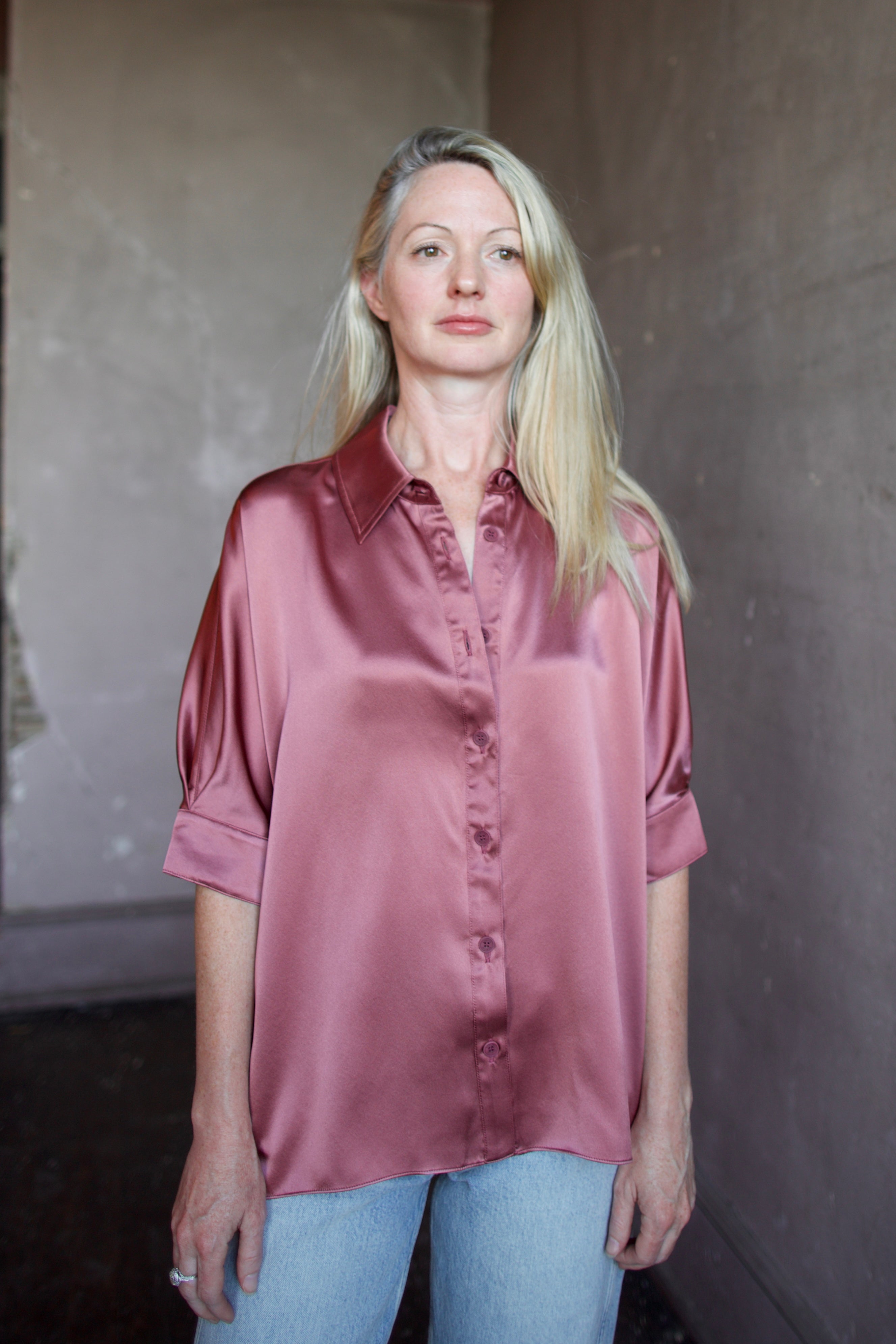 Model wearing luxury designer Sablyn silk charmeuse Gisele B relaxed short sleeve button down blouse with collar