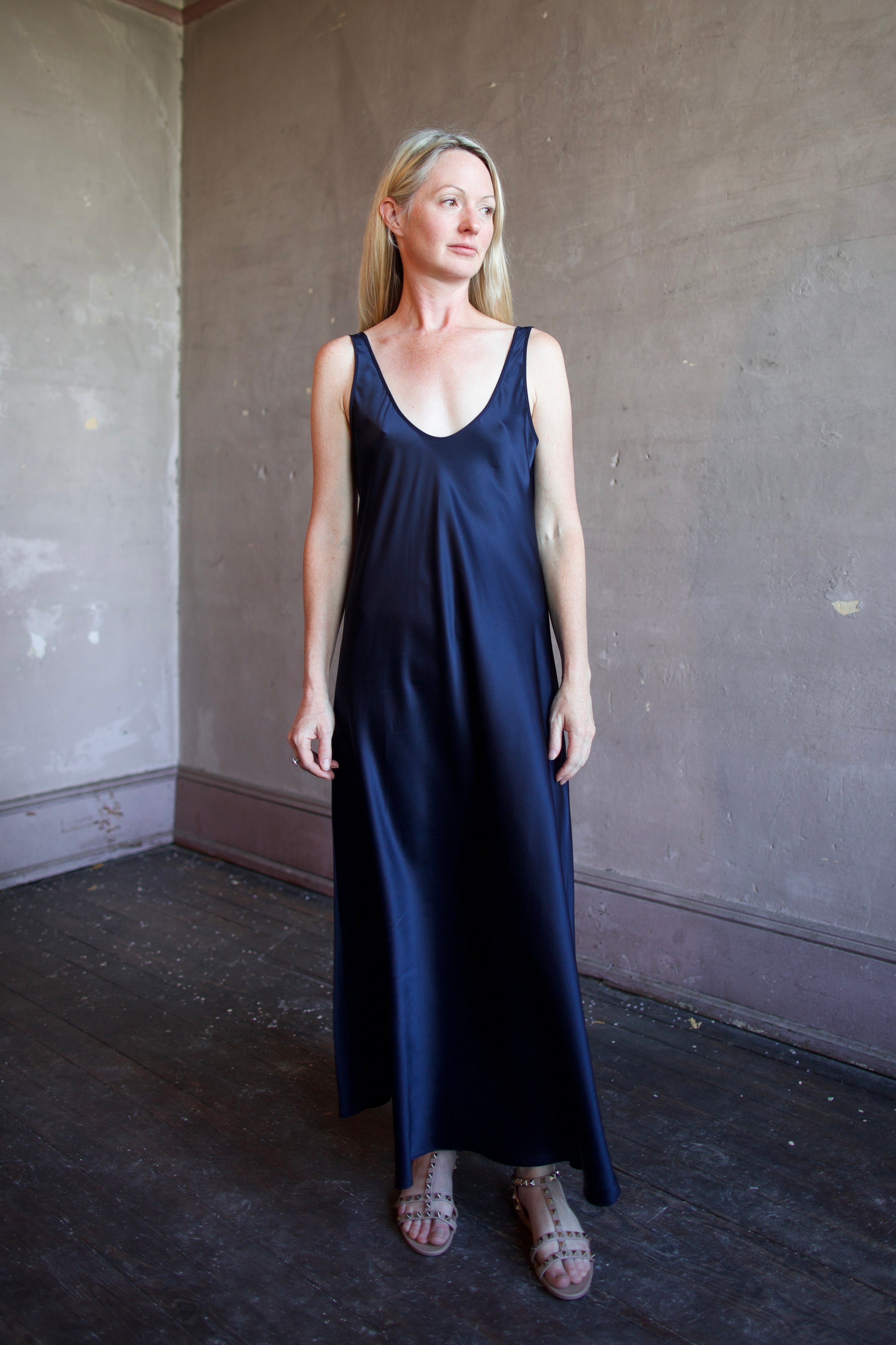 Model wearing luxury brand Sablyn silk charmeuse slip maxi dress with scoop neck and low back
