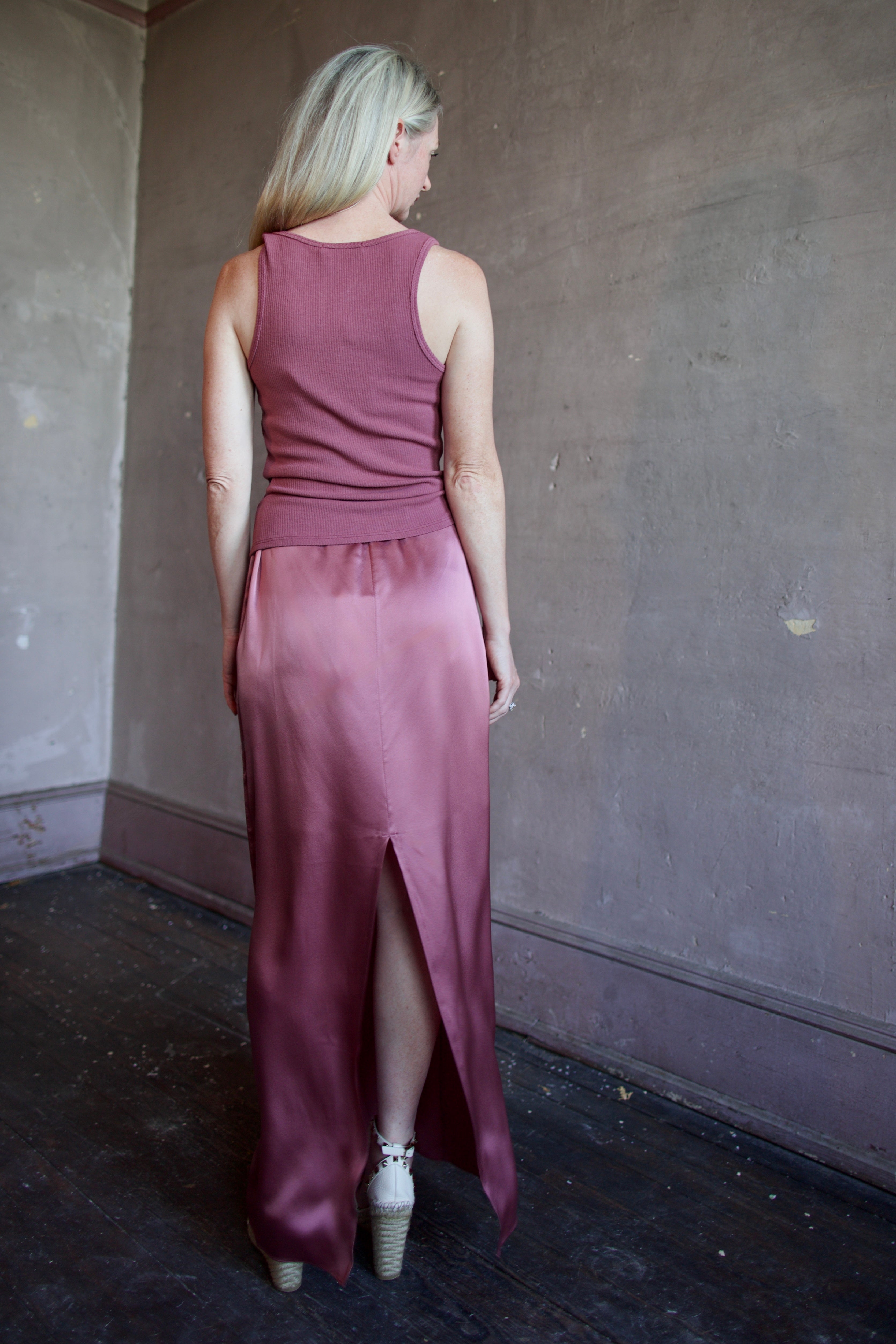 Model wearing luxury brand Sablyn Sol Drawsting waist maxi skirt in premium silk charmeuse fabric and rich mauve colorway