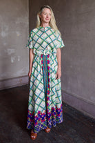 Mature woman wearing the Saloni Jude-B short sleeve plaid button up crop top crafted in cotton with happy diagonal green plaid expertly aligned pattern and matching skirt as a set