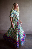 Mature woman wearing the Saloni Jude-B short sleeve plaid button up crop top crafted in cotton with happy diagonal green plaid expertly aligned pattern and matching skirt as a set