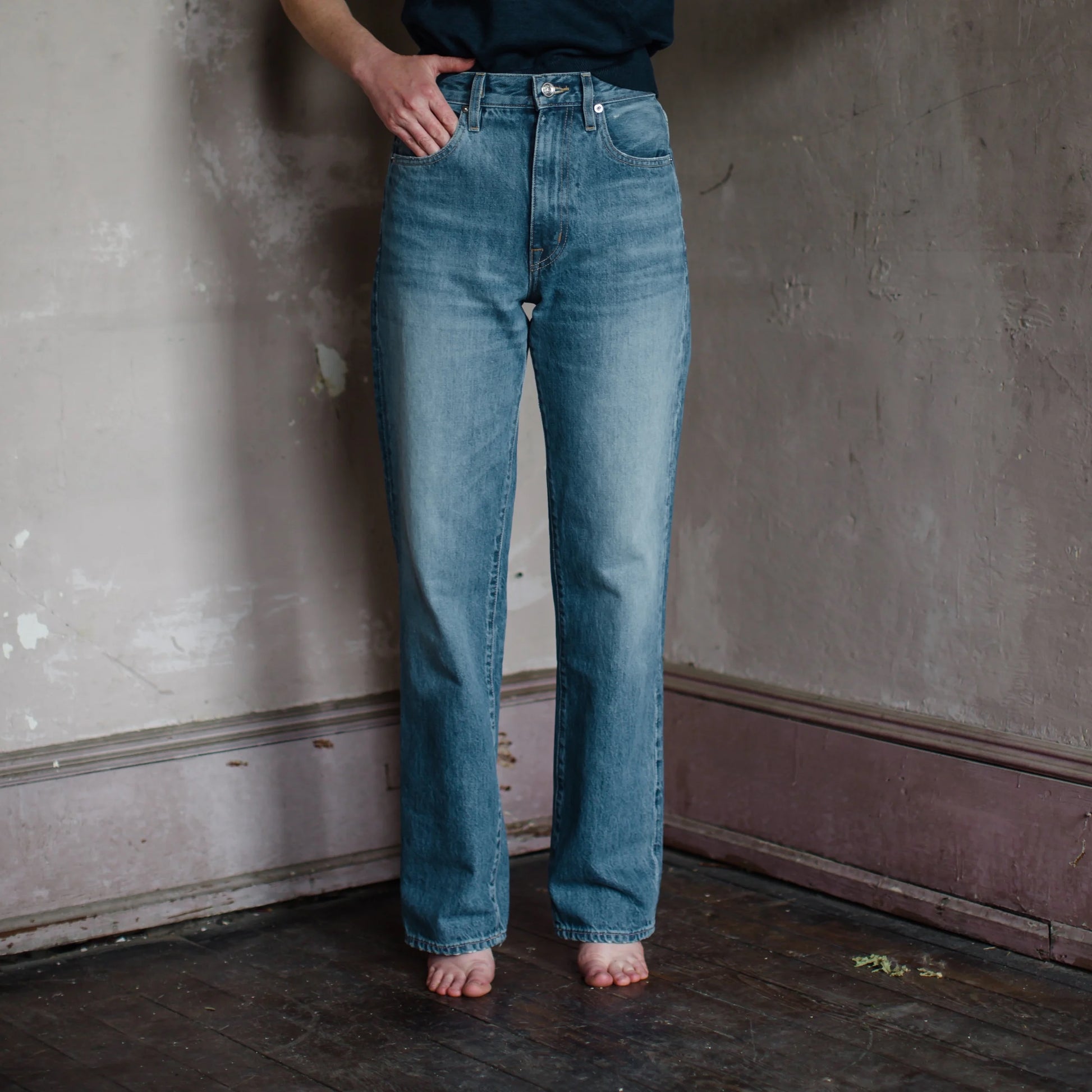 Image featuring a woman wearing the London Jean by Slvrlake in a high- rise, straight leg, rigid denim with button and concealed zip fastening at front. with a finished seam.