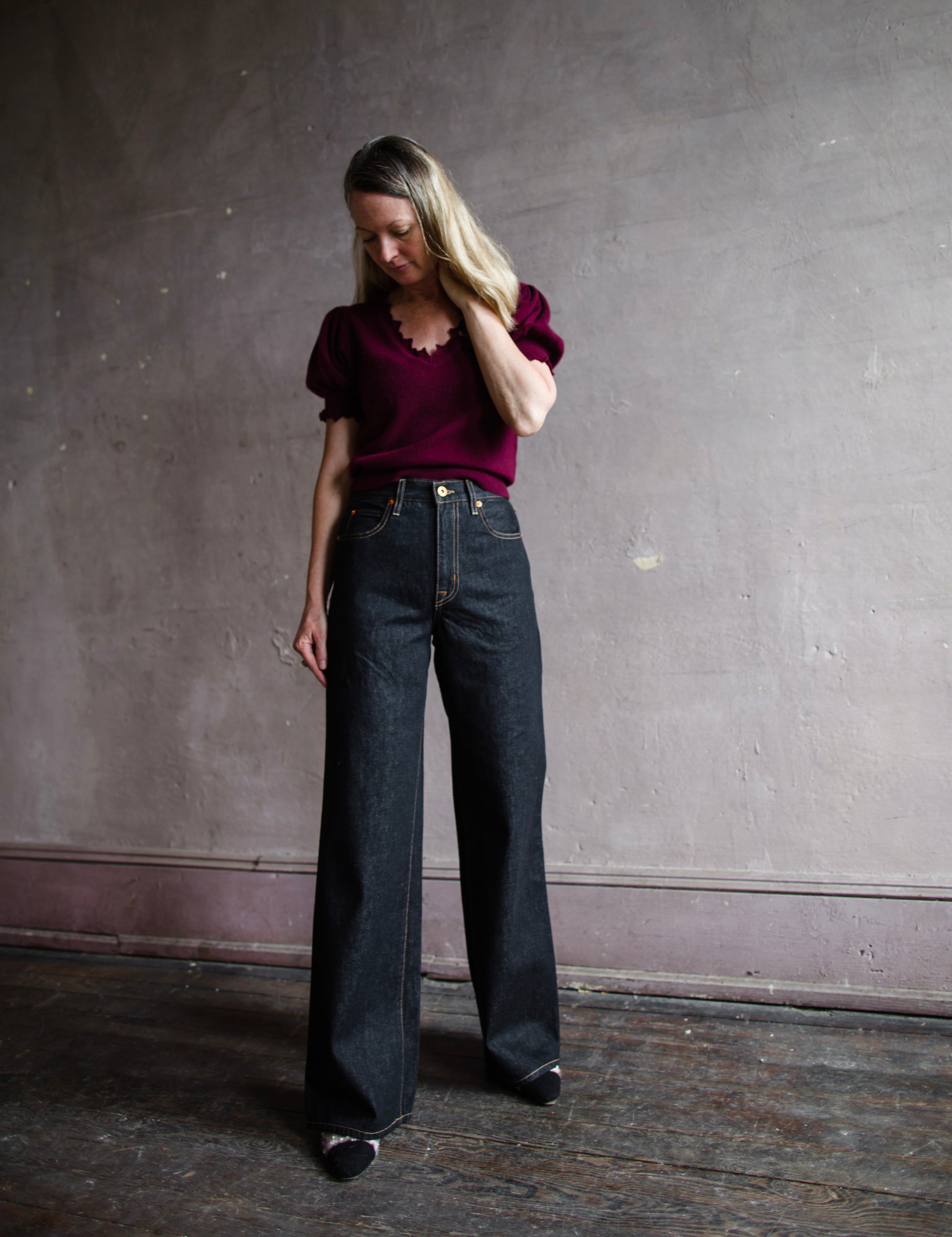 Image featuring a woman wearing the Grace jeans by Slvrlake feature a high rise and wide leg in a black finish called empty sky.