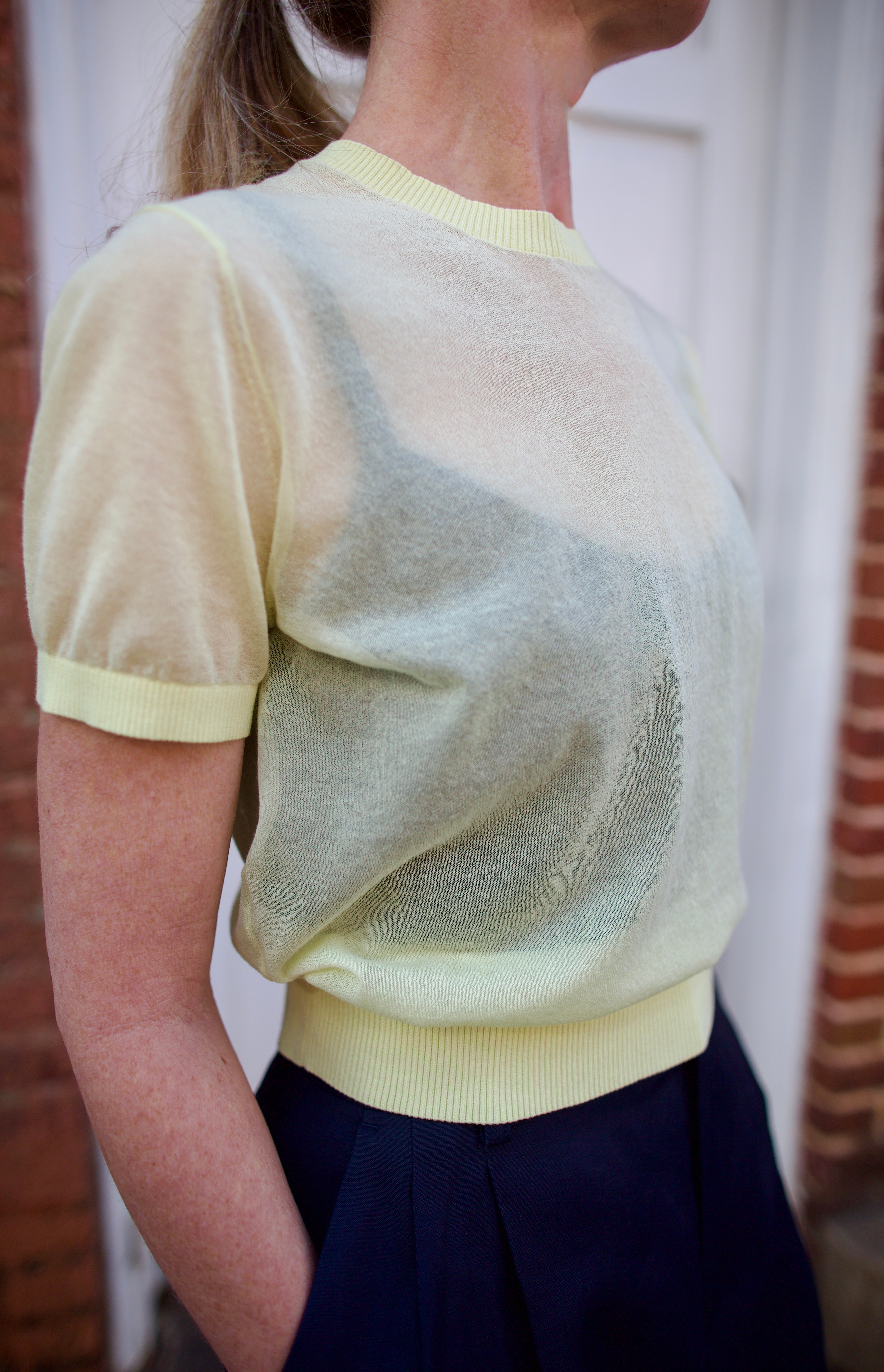 Close up image of a woman wearing the Soeur Dua Pullover and Tailored Shorts