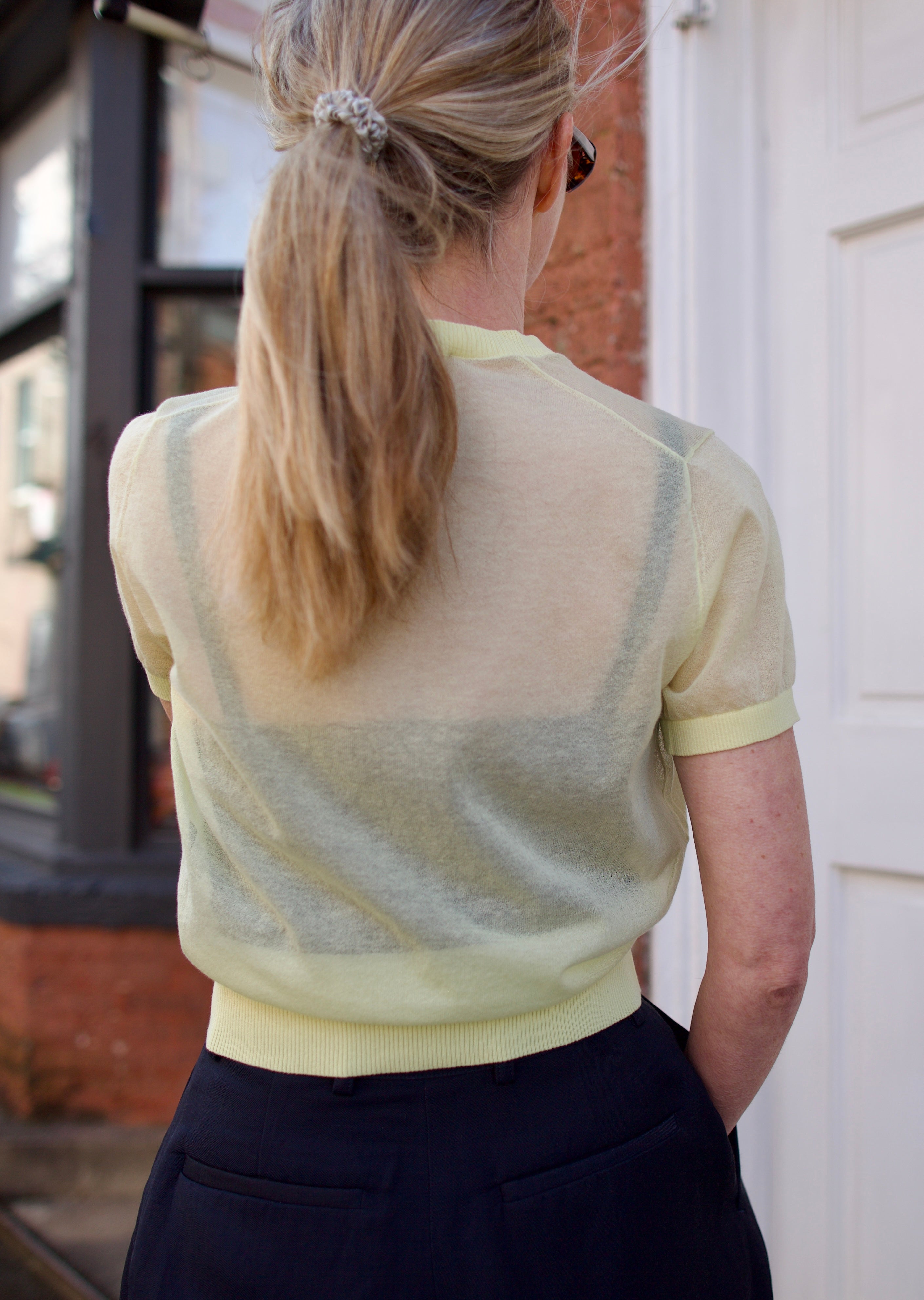 Back image of a woman wearing the Soeur Dua Pullover and tailored shorts