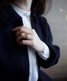 Image featuring a woman wearing North Carolina artist Stephanie Ellis stacker ring in 14-karat recycled yellow gold, 0.40ct salt and pepper kite-shaped diamond.