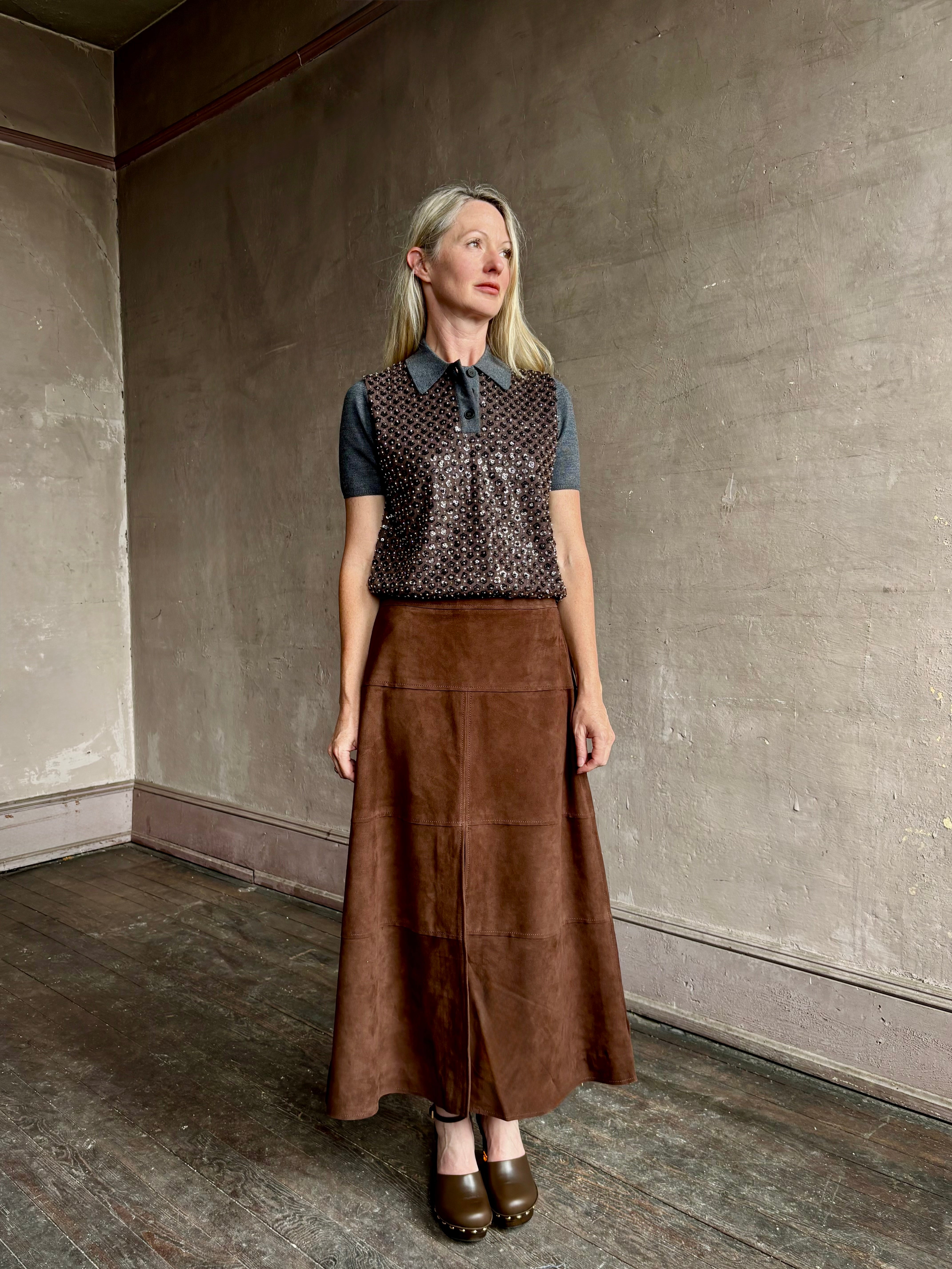 Image of mature woman wearing contemporary designer Tanya Taylor luxurious Suede classic A-Line Hudson Skirt in Chocolate brown
