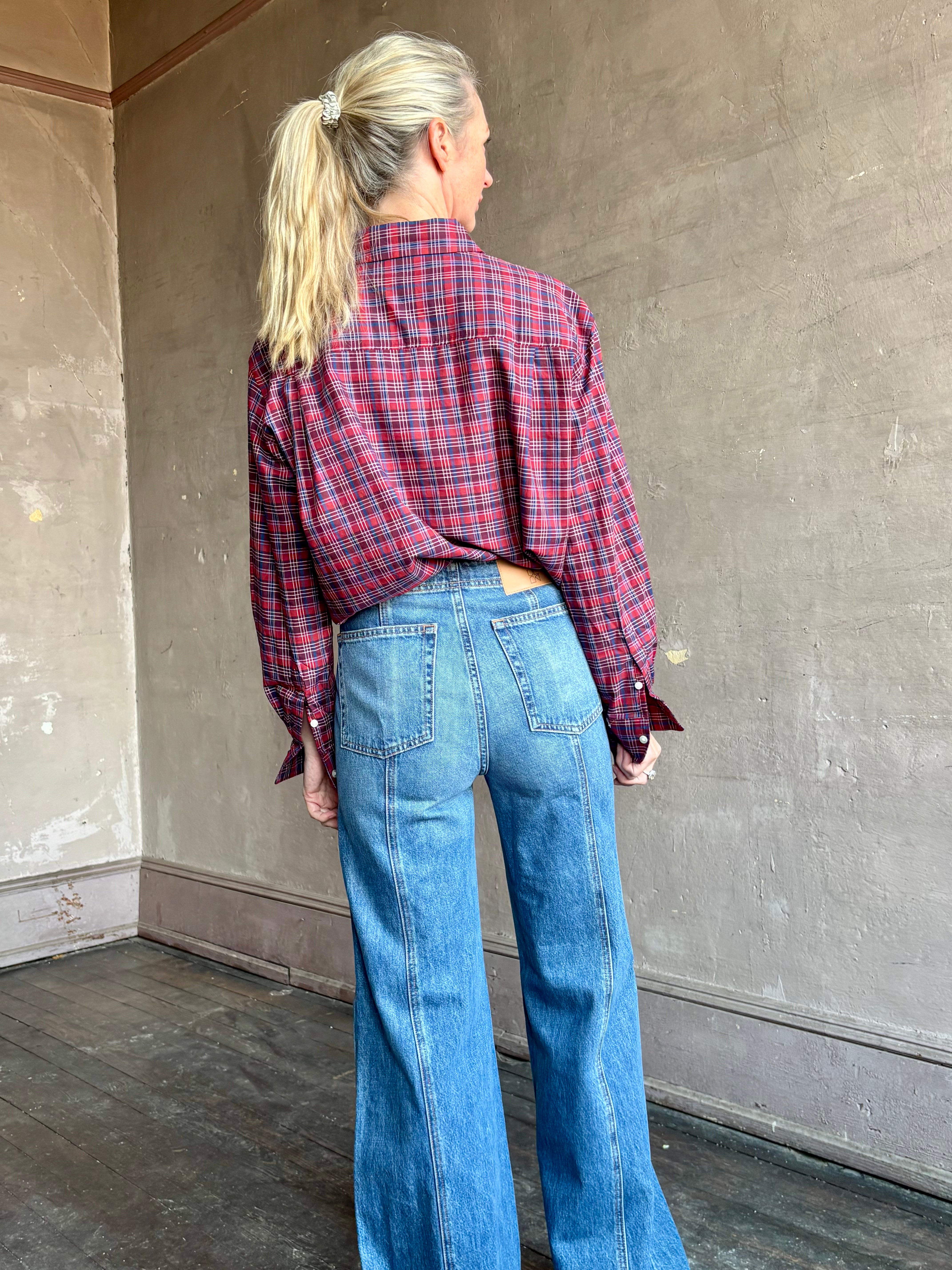 Image of mature woman wearing Trovata Blake Oversized premium cotton button down long sleeve Shirt in Mulled Wine Plaid 