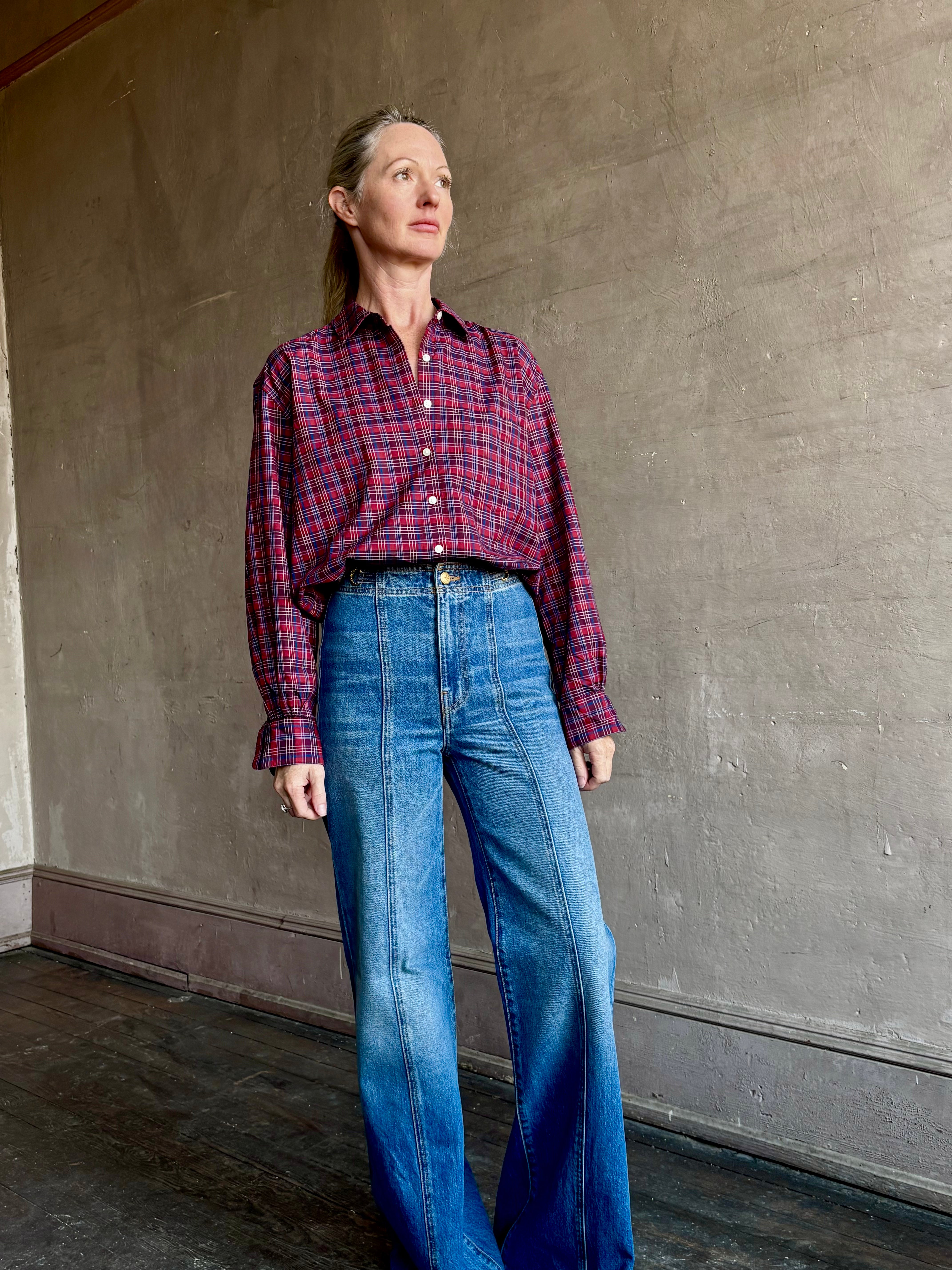 Image of mature woman wearing Trovata Blake Oversized premium cotton button down long sleeve Shirt in Mulled Wine Plaid 