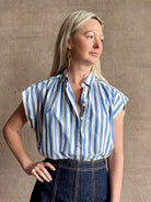 Mature woman wearing elevated everyday short sleeve cotton button-down Della Shirt from Trovata in a playful blue and white summer stripe
