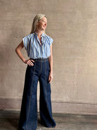 Mature woman wearing elevated everyday short sleeve cotton button-down Della Shirt from Trovata in a playful blue and white summer stripe