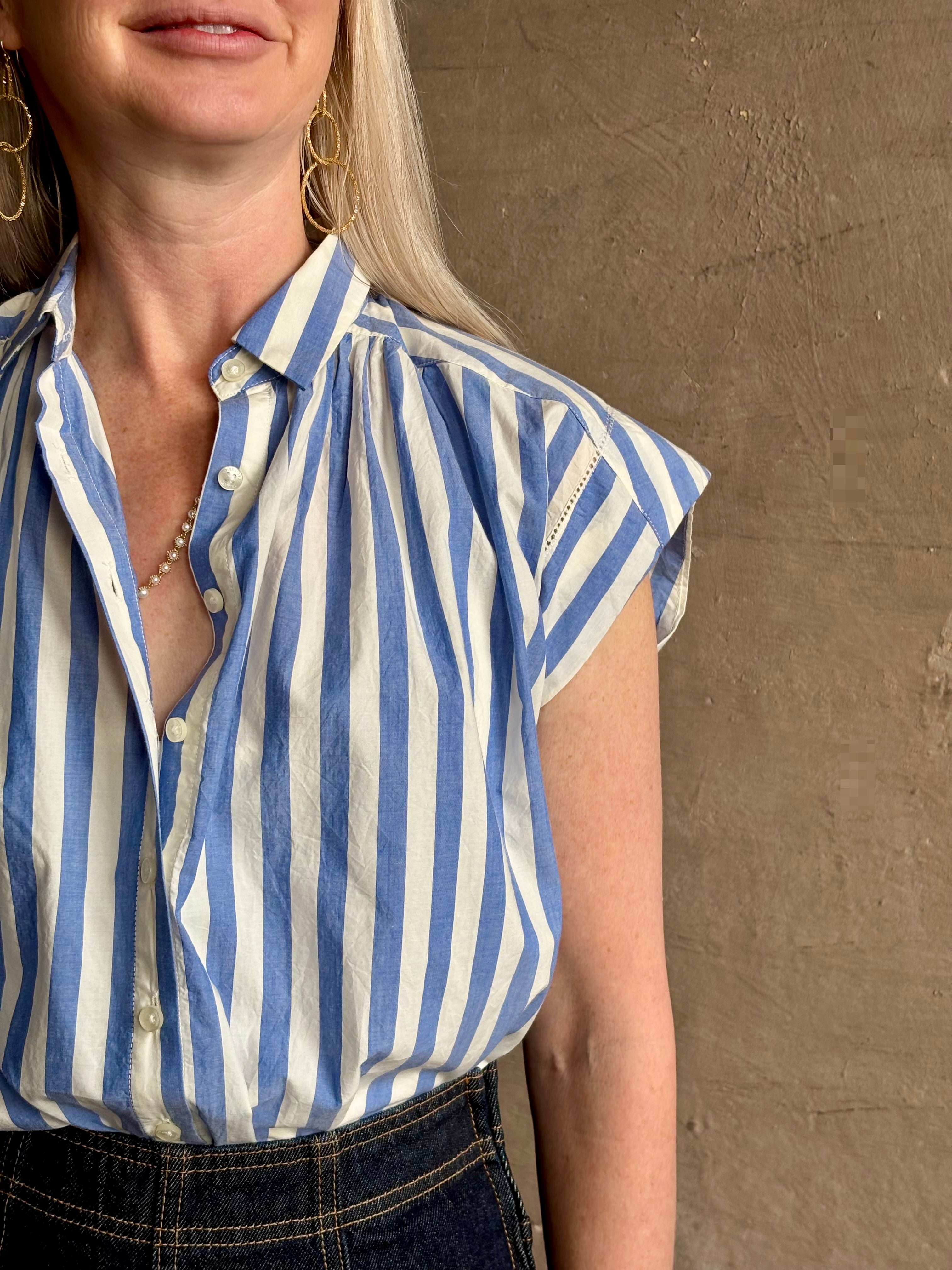 Mature woman wearing elevated everyday short sleeve cotton button-down Della Shirt from Trovata in a playful blue and white summer stripe