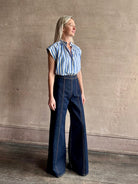 Mature woman wearing elevated everyday short sleeve cotton button-down Della Shirt from Trovata in a playful blue and white summer stripe