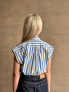 Mature woman wearing elevated everyday short sleeve cotton button-down Della Shirt from Trovata in a playful blue and white summer stripe