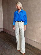 Image of woman wearing the ultimate casual elegance TROVATA Emilia cotton blend button down long sleeve Shirt in Cerulean blue contemporary floral print 