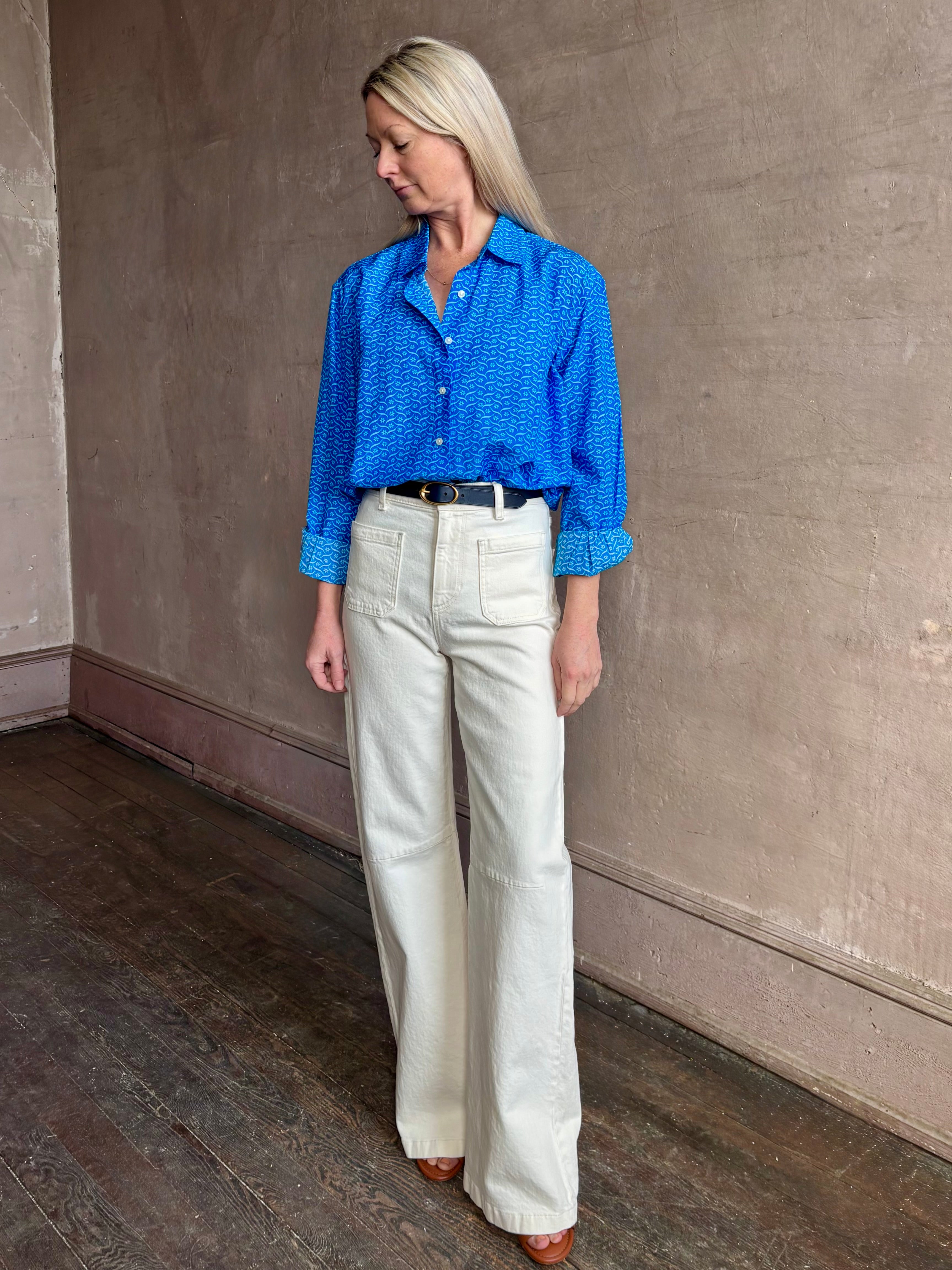 Image of woman wearing the ultimate casual elegance TROVATA Emilia cotton blend button down long sleeve Shirt in Cerulean blue contemporary floral print 