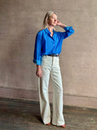 Image of woman wearing the ultimate casual elegance TROVATA Emilia cotton blend button down long sleeve Shirt in Cerulean blue contemporary floral print 