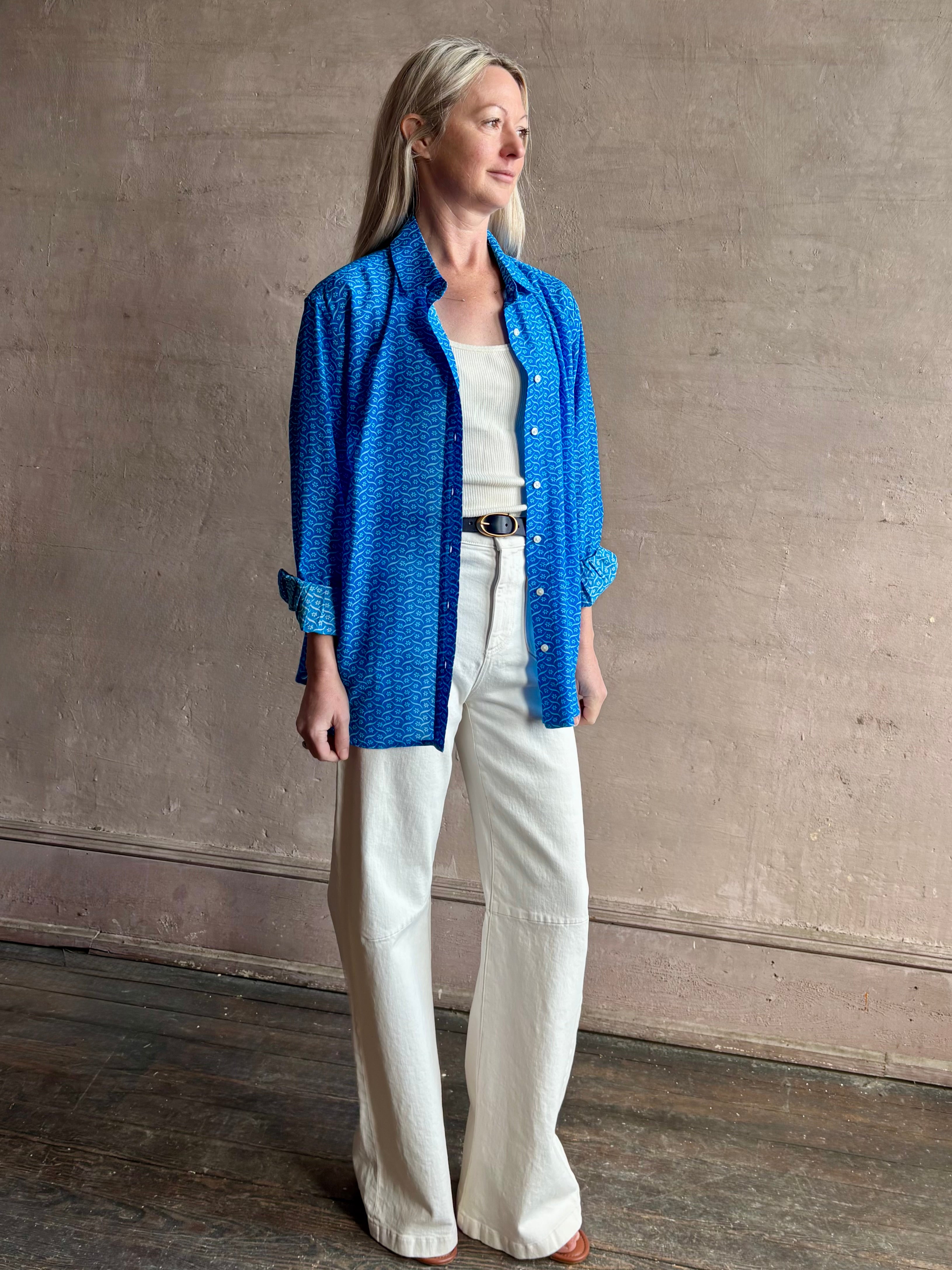 Image of woman wearing the ultimate casual elegance TROVATA Emilia cotton blend button down long sleeve Shirt in Cerulean blue contemporary floral print 