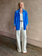 Image of woman wearing the ultimate casual elegance TROVATA Emilia cotton blend button down long sleeve Shirt in Cerulean blue contemporary floral print 