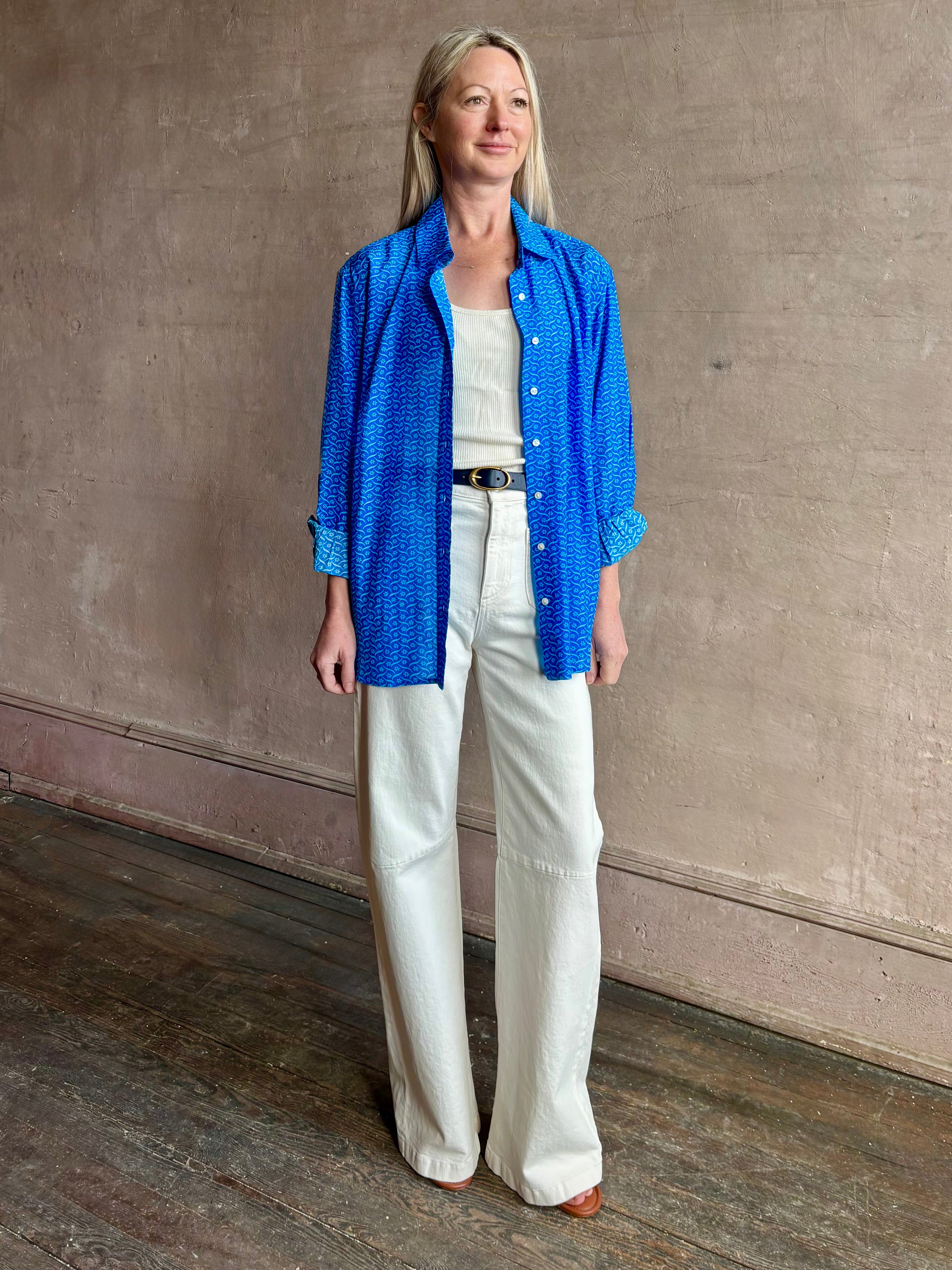 Image of woman wearing the ultimate casual elegance TROVATA Emilia cotton blend button down long sleeve Shirt in Cerulean blue contemporary floral print 