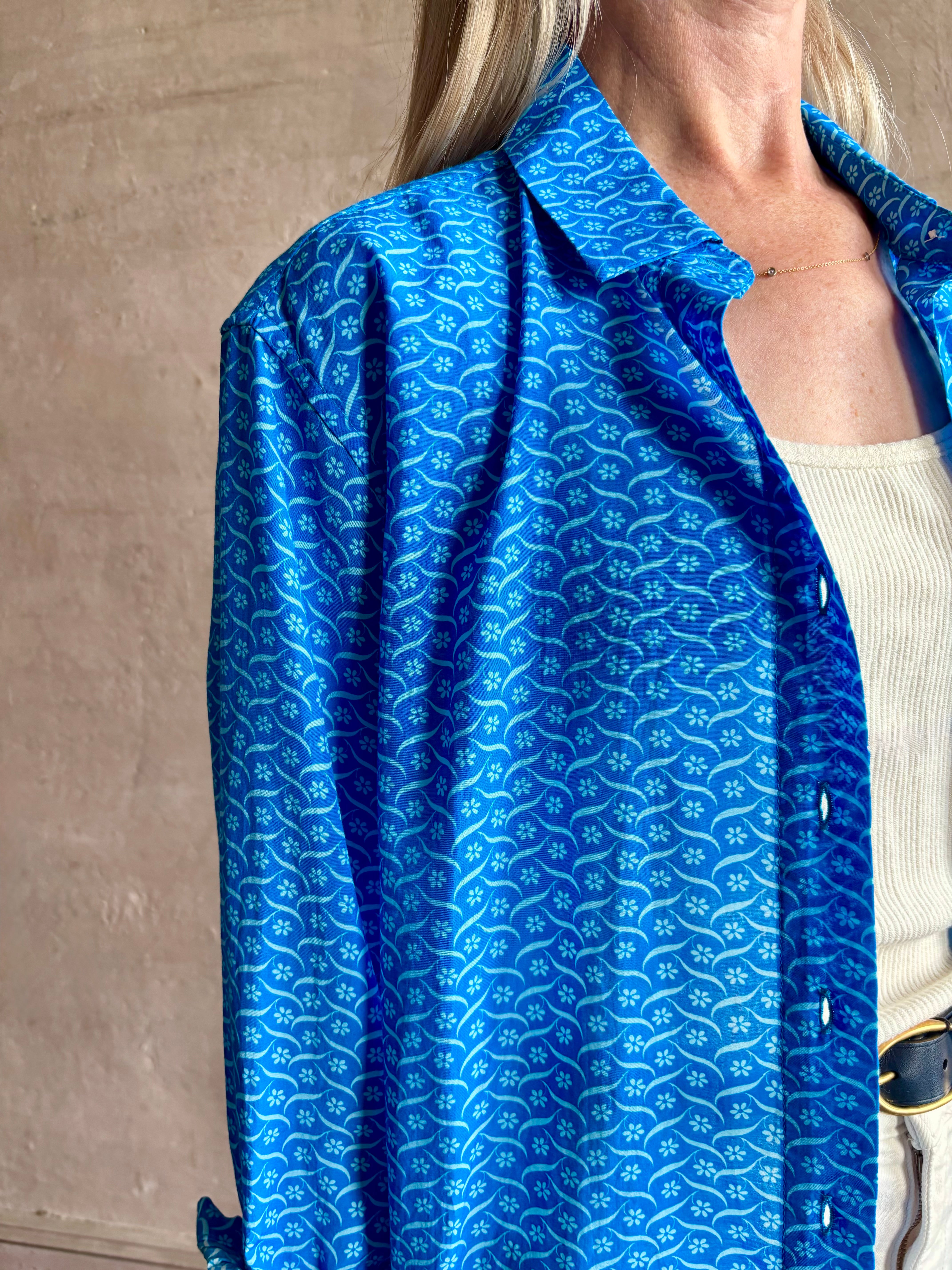 Image of woman wearing the ultimate casual elegance TROVATA Emilia cotton blend button down long sleeve Shirt in Cerulean blue contemporary floral print 