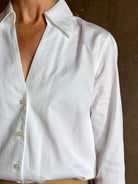 woman wearing white Trovata Justine blouse collared V-neck button-front closure cuffed long sleeves classic silhouette 